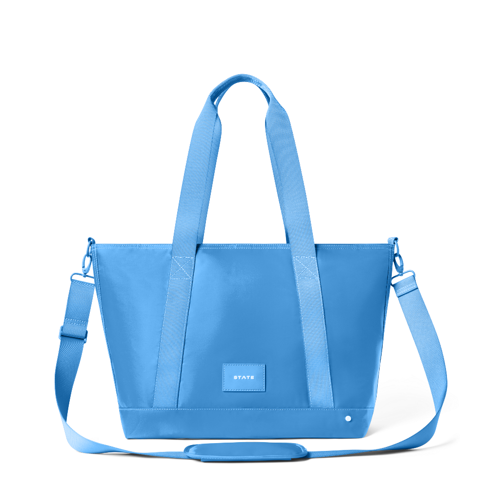 Blue tote bag with shoulder strap on a white background