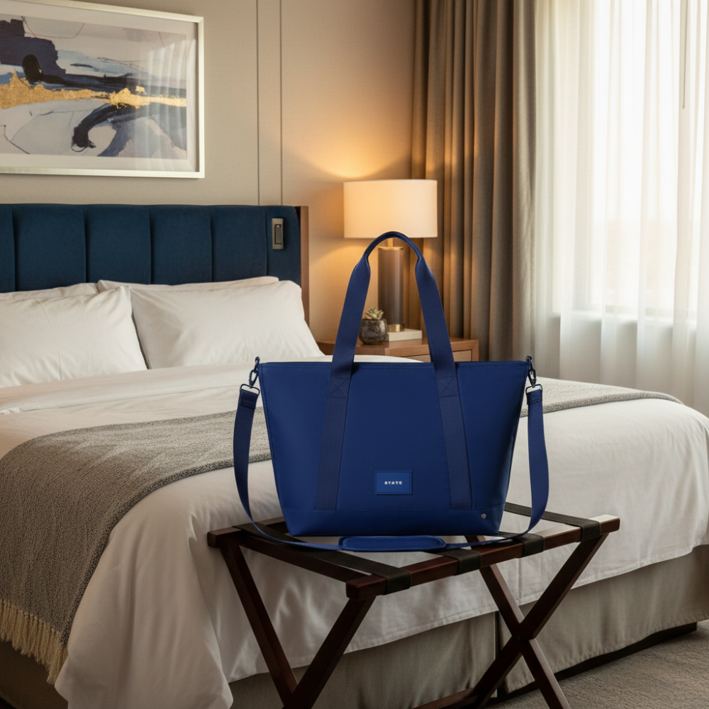 Blue tote bag with shoulder strap on a white background