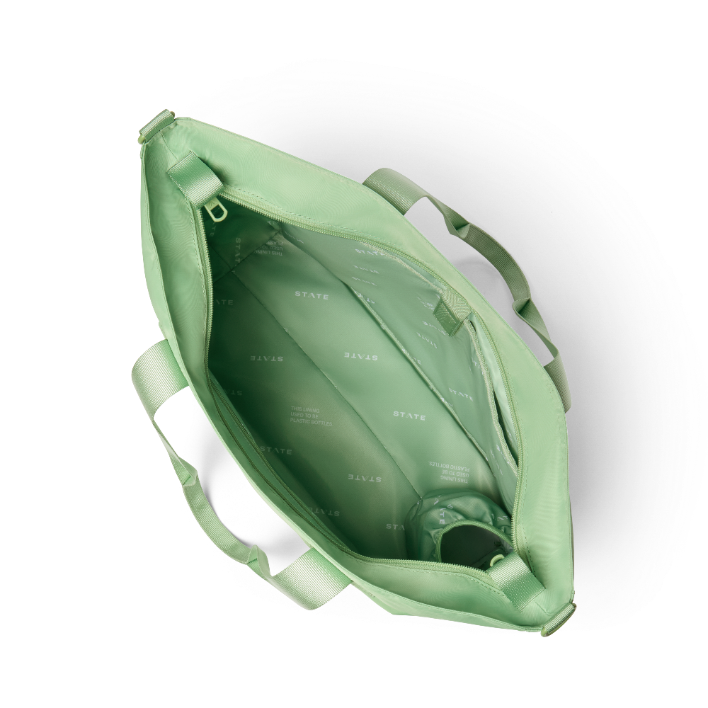 Green tote bag with visible branding on a white background