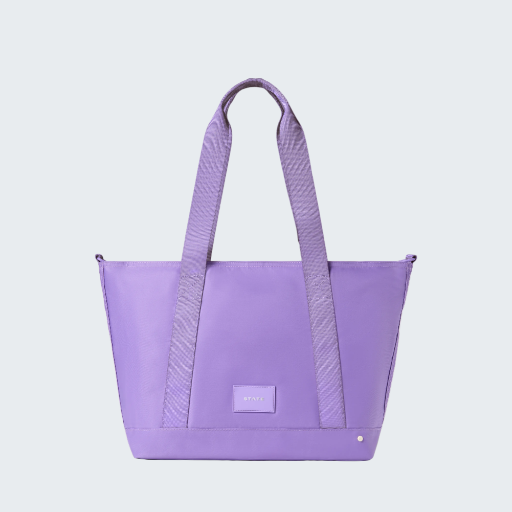 Purple tote bag with a visible brand logo on a white background