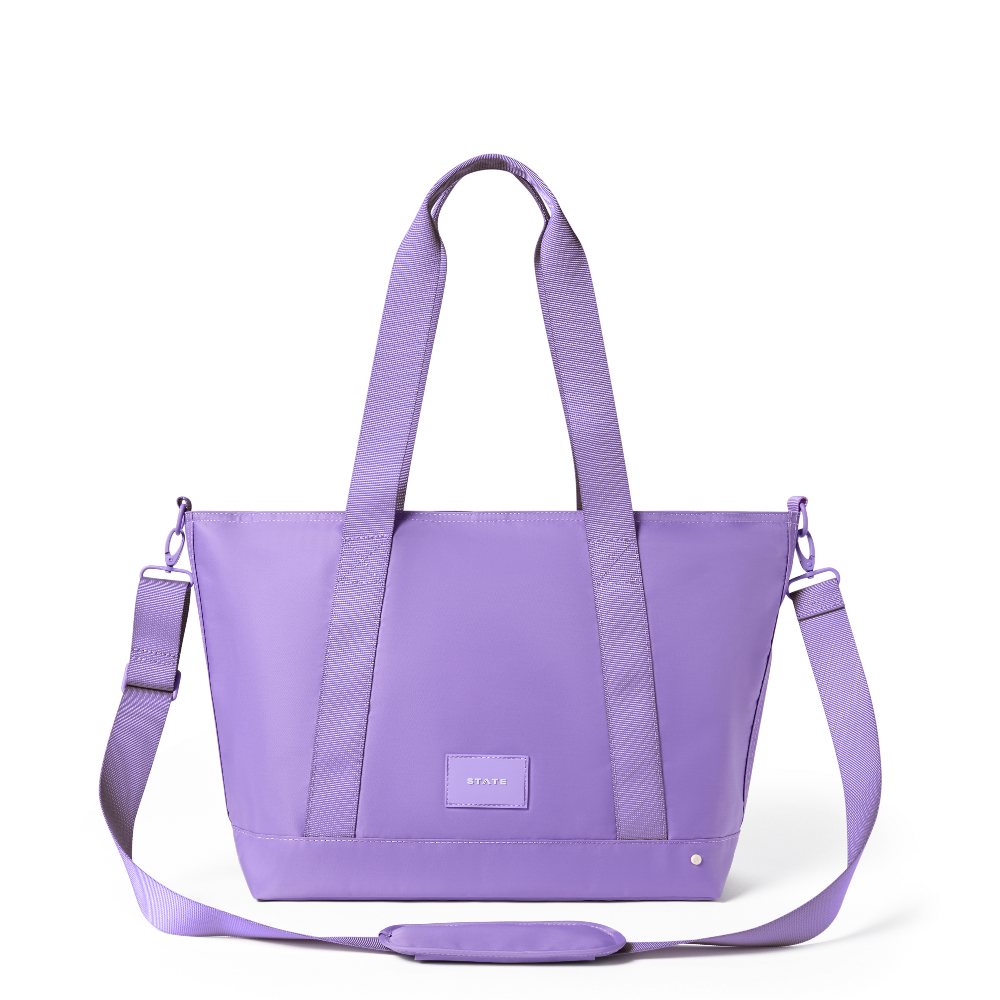 Purple tote bag with a strap on a white background