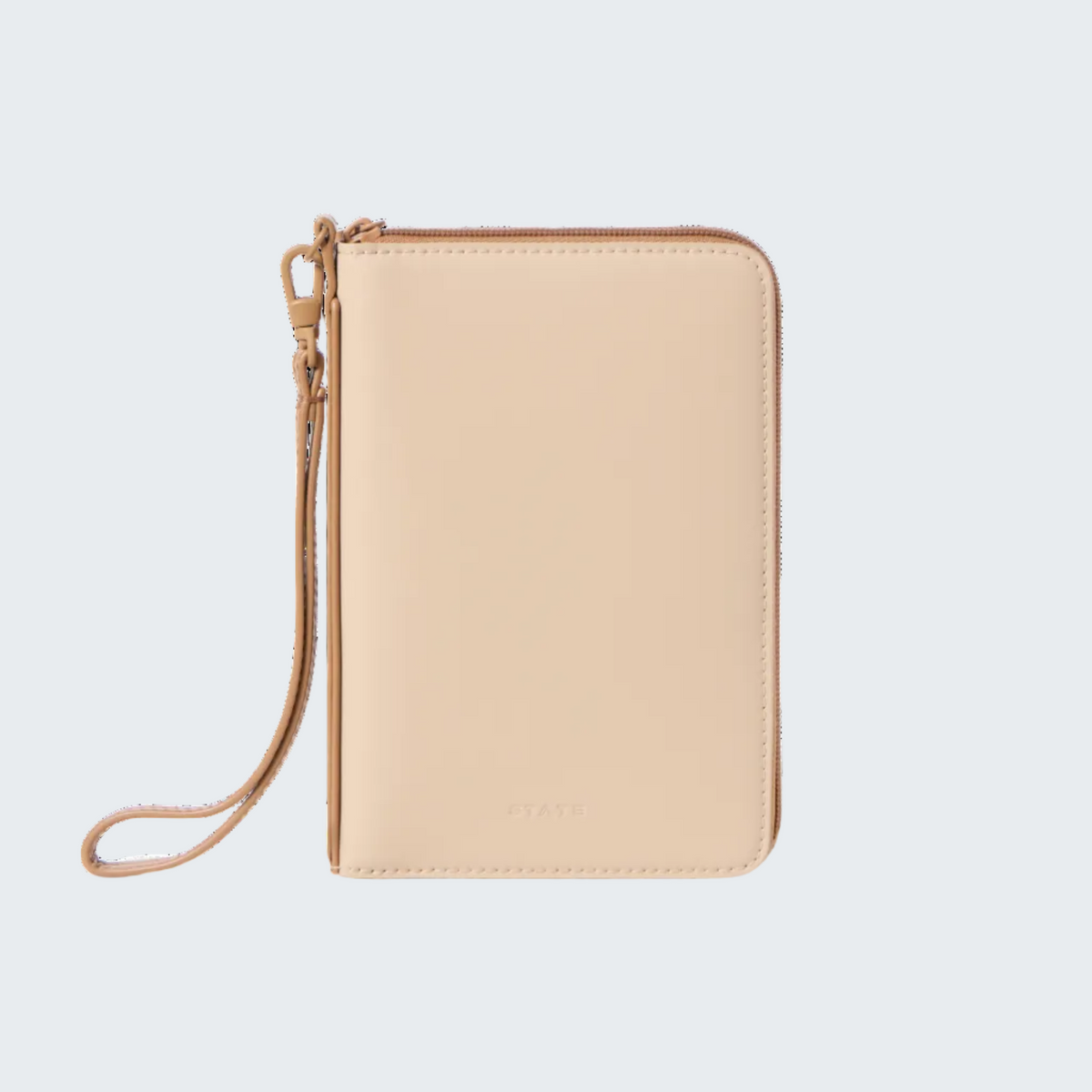A slim, rectangular zip-around wallet or passport holder in a light beige leather finish with a matching wristlet strap, shown on a plain white background.