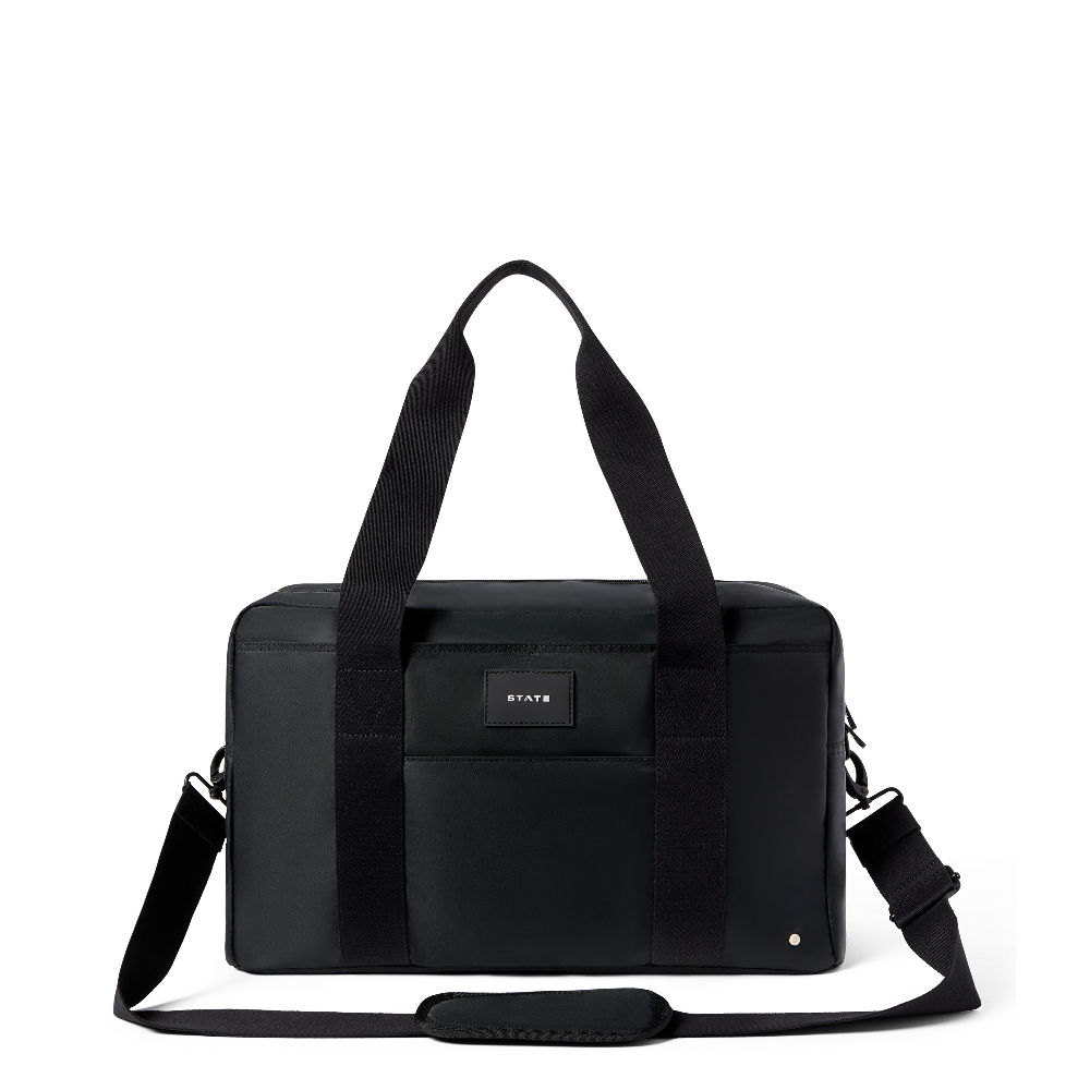 Black duffel bag with shoulder strap on a white background