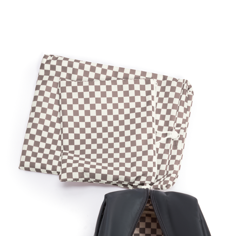 Checkered fabric over a black bag on a white background