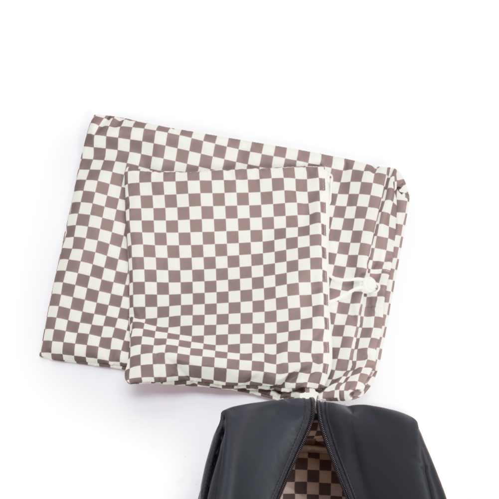 Checkered fabric over a black bag on a white background