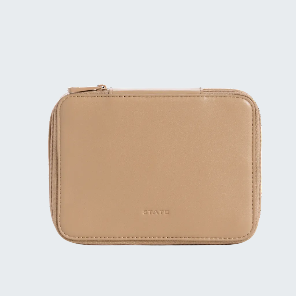 A small beige leather zip-around wallet with rounded corners and a debossed STATE logo on the front, photographed against a solid white background.