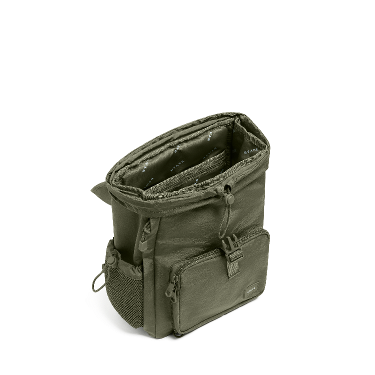 An olive green roll-top camera bag with multiple zippered pockets and a side mesh pocket, shown open on a white background.