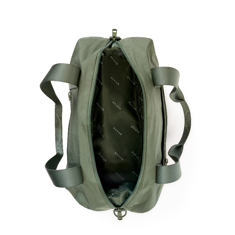 An olive green duffel bag shown from a top-down view, open to reveal a black interior lined with the brand name 'KALVAR' repeated in white. The bag features dual shoulder straps and a top zipper closure, photographed on a clean white background.