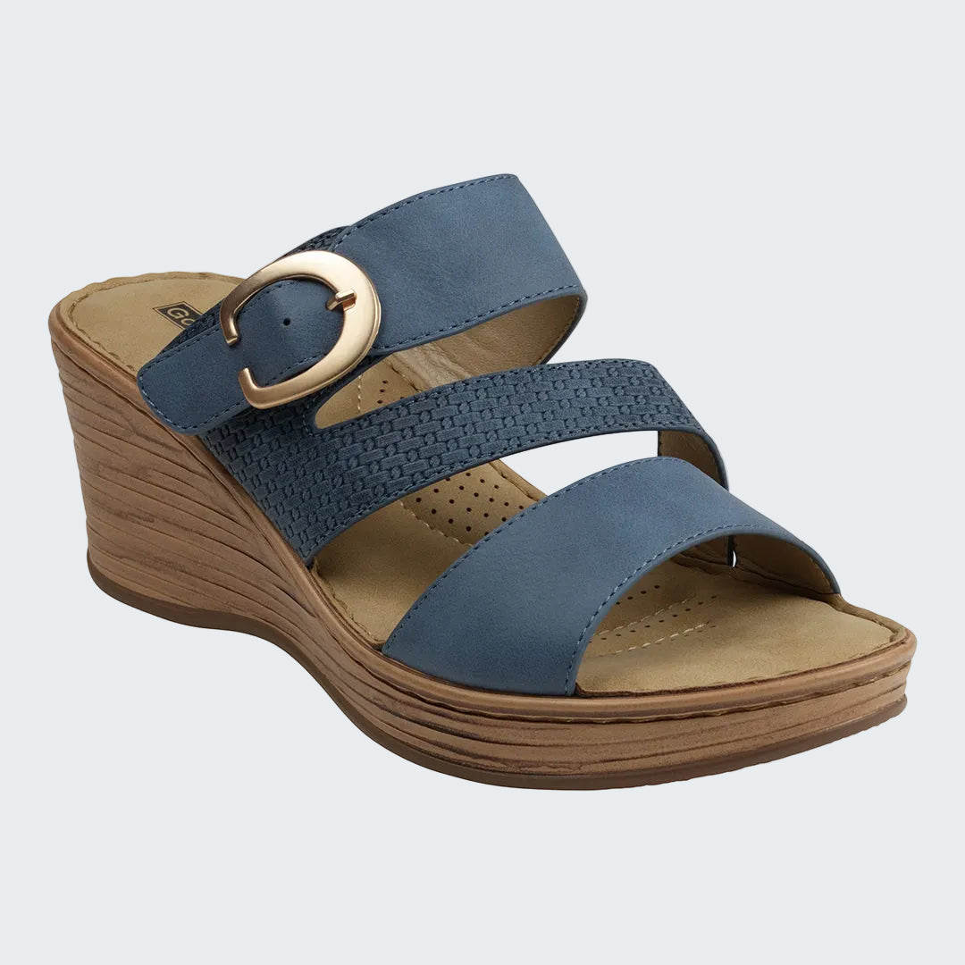 Blue wedge sandal with a gold buckle on a white background