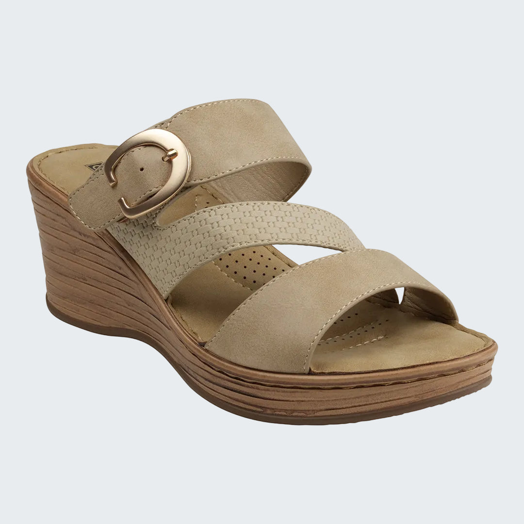 Beige wedge sandal with a gold buckle on a white background