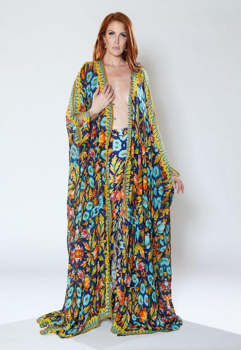 Woman wearing a colorful floral dress on a white background