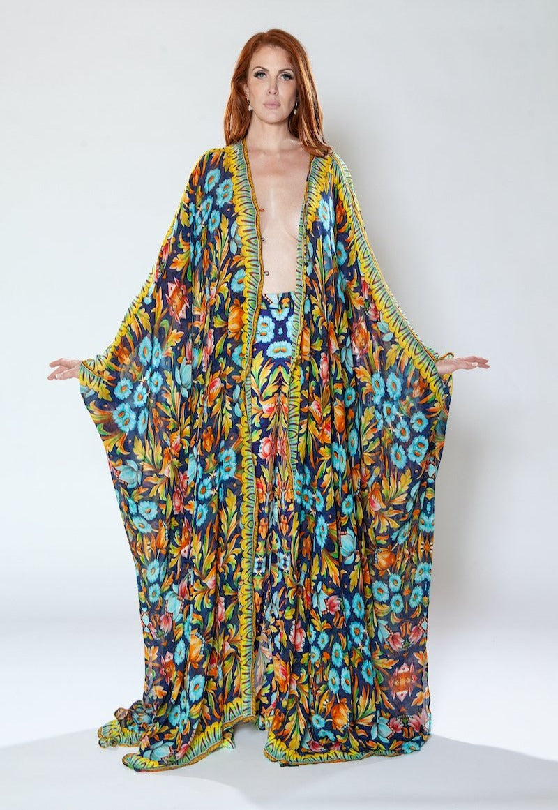 Woman wearing a colorful floral dress against a white background