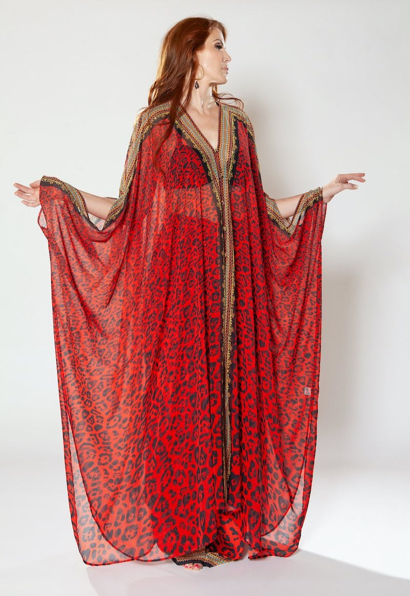 Woman wearing a red patterned dress with a white background