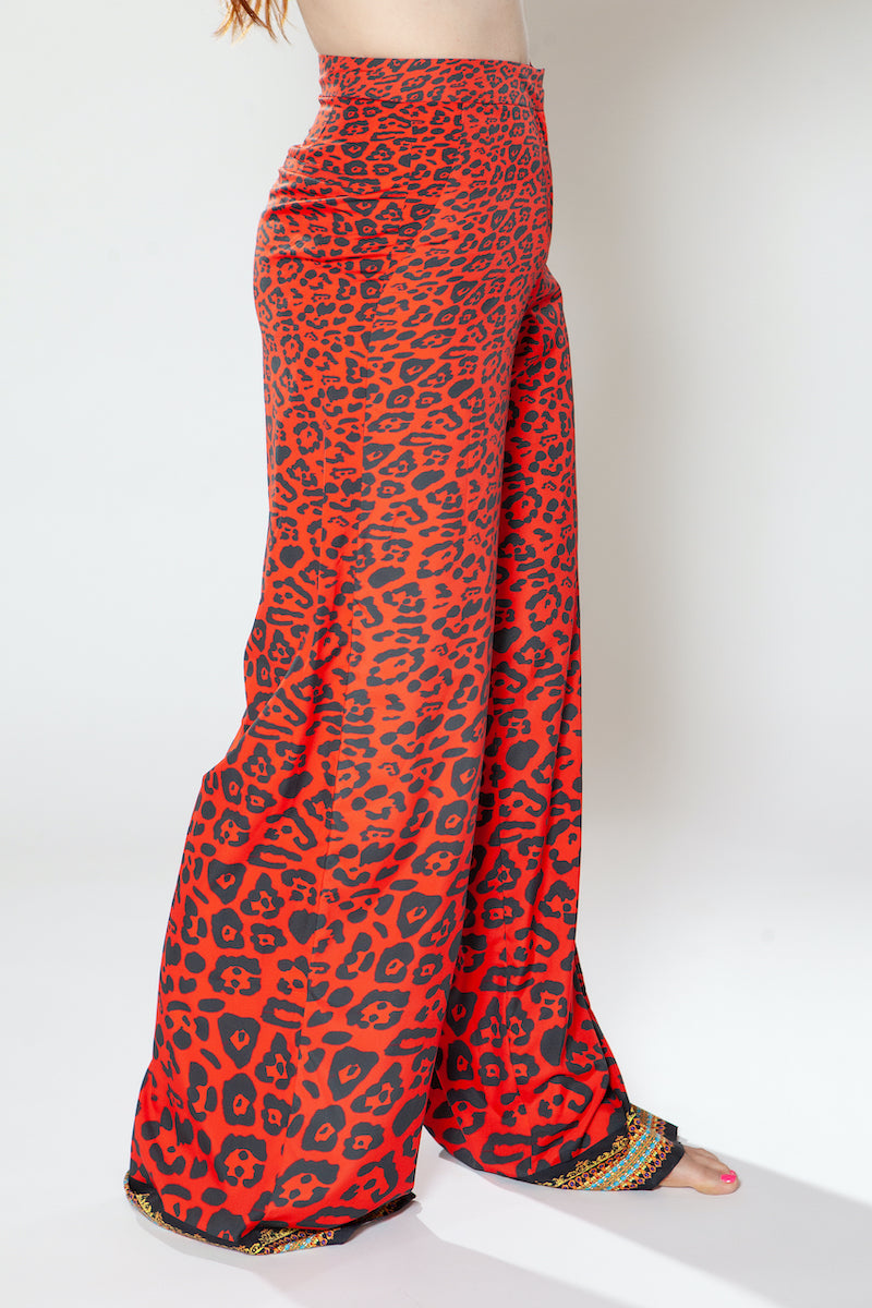Red leopard print pants on a white background