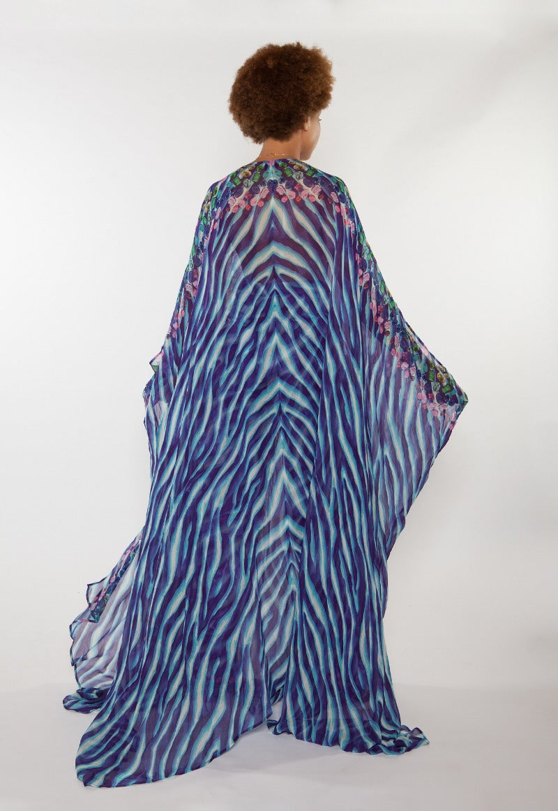 Person wearing a colorful, patterned kimono-style garment on a white background