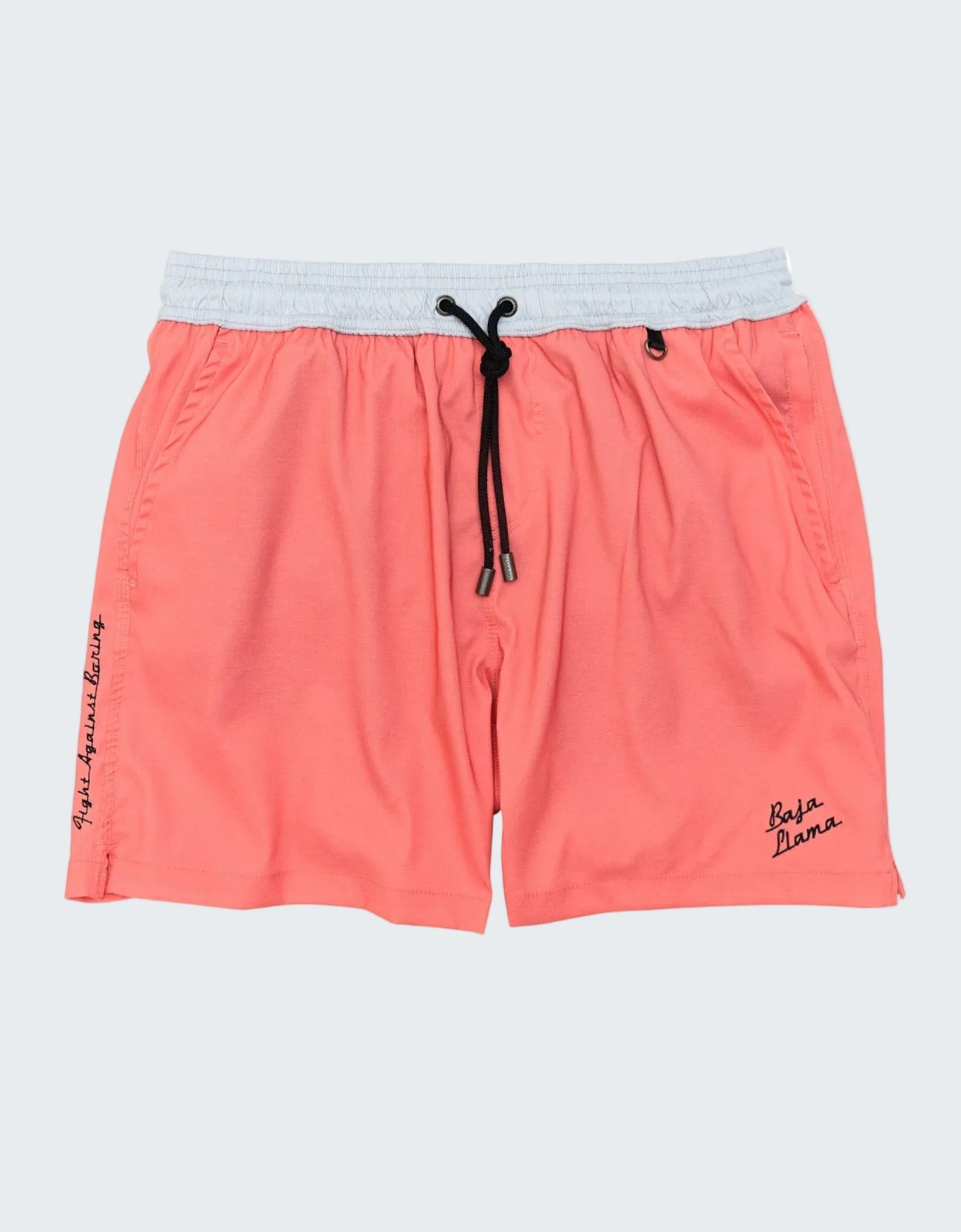 Coral pink athletic shorts with a light gray elastic waistband, black drawstring, and small black script logos on the sides, shown against a plain white background.