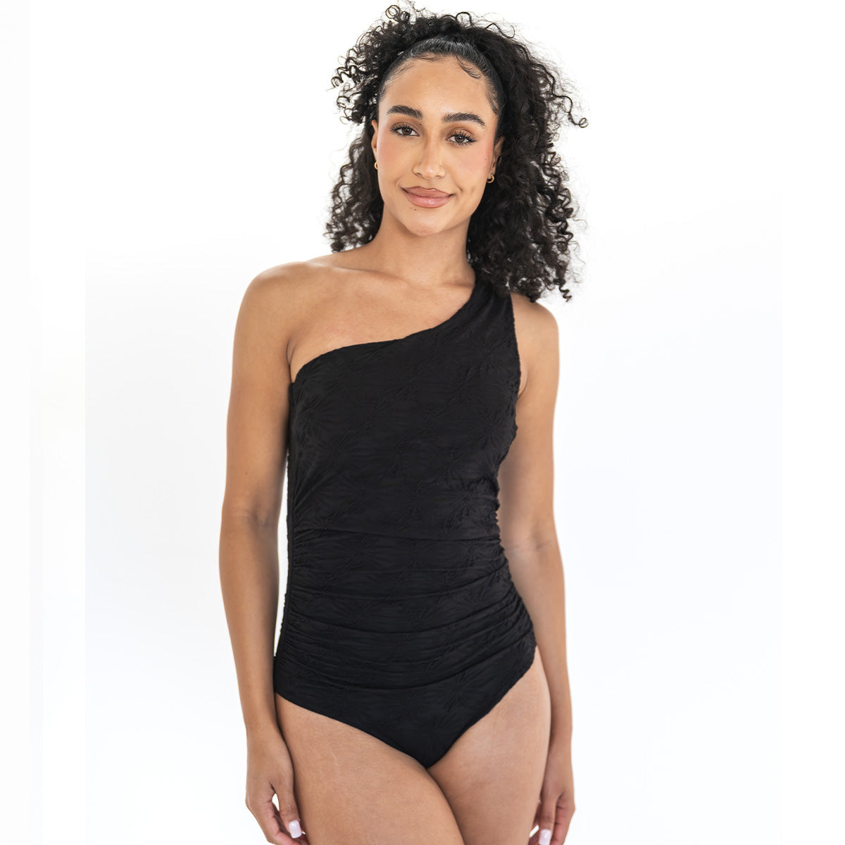 Woman wearing a black one-shoulder swimsuit on a white background