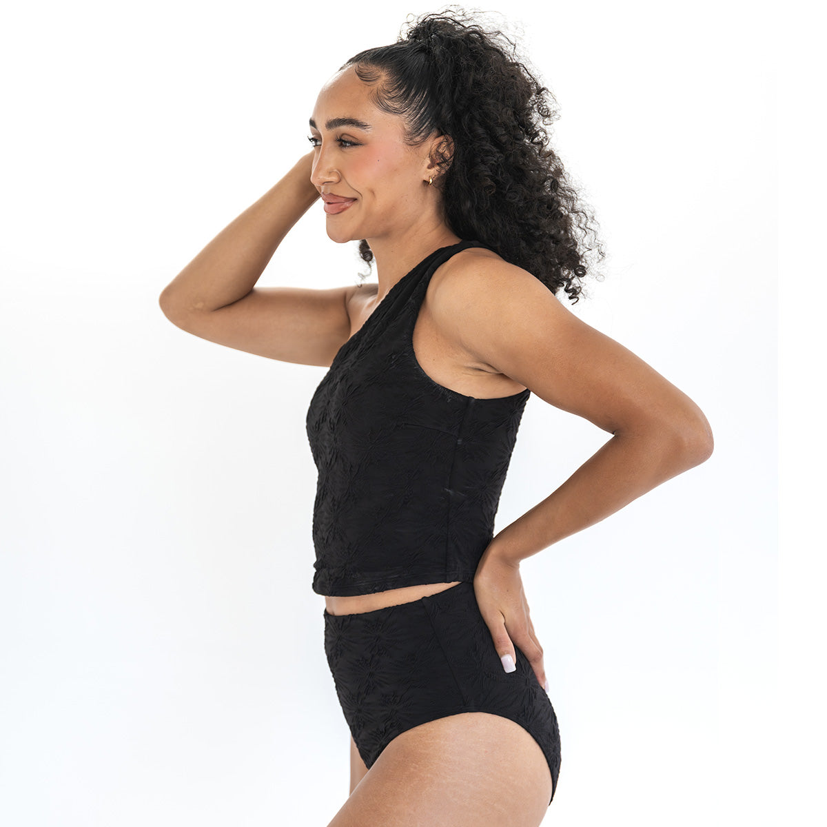 Woman wearing a black athletic outfit on a white background