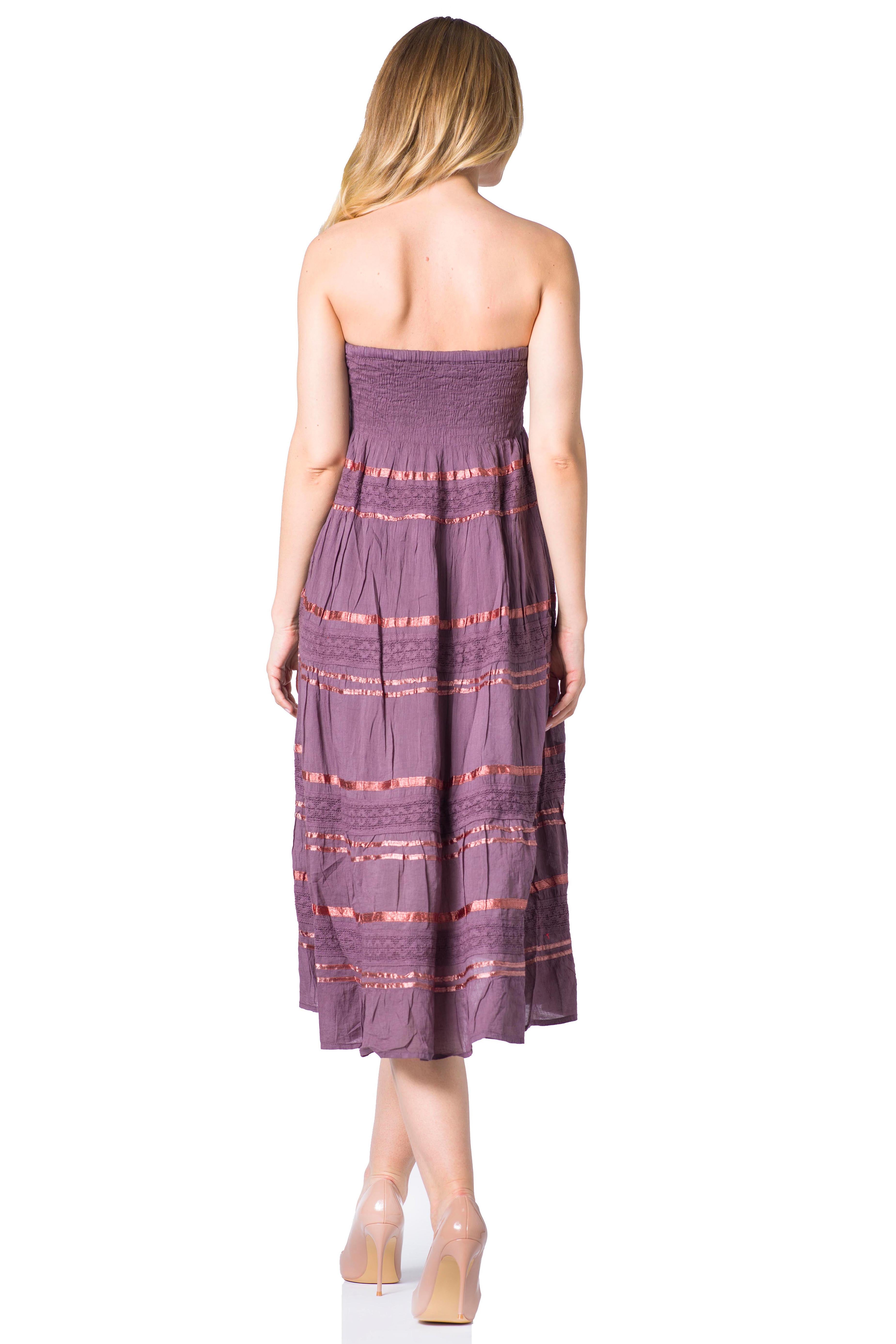 Woman wearing a strapless purple dress with a white background