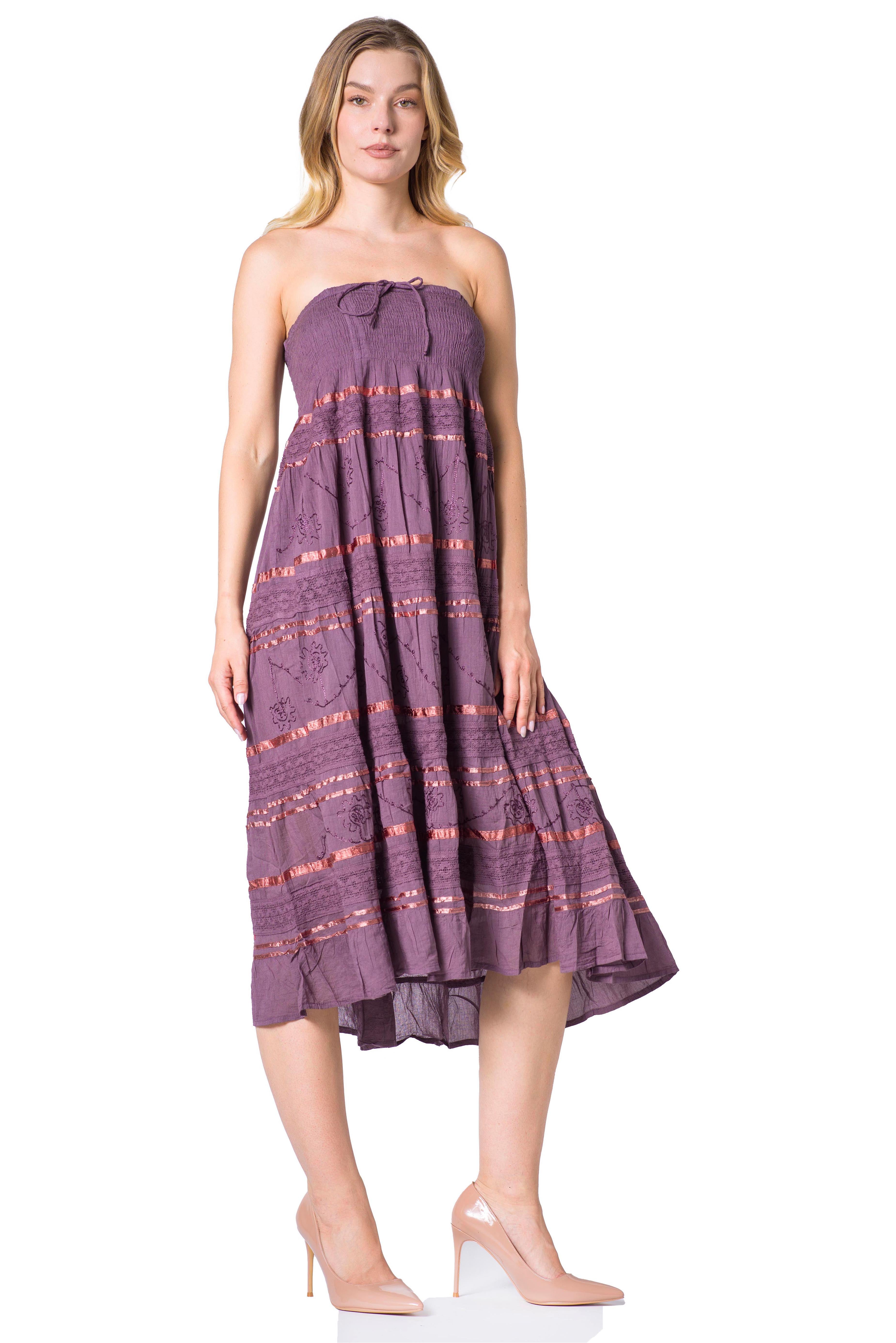 Woman wearing a purple strapless dress with a pattern on a white background
