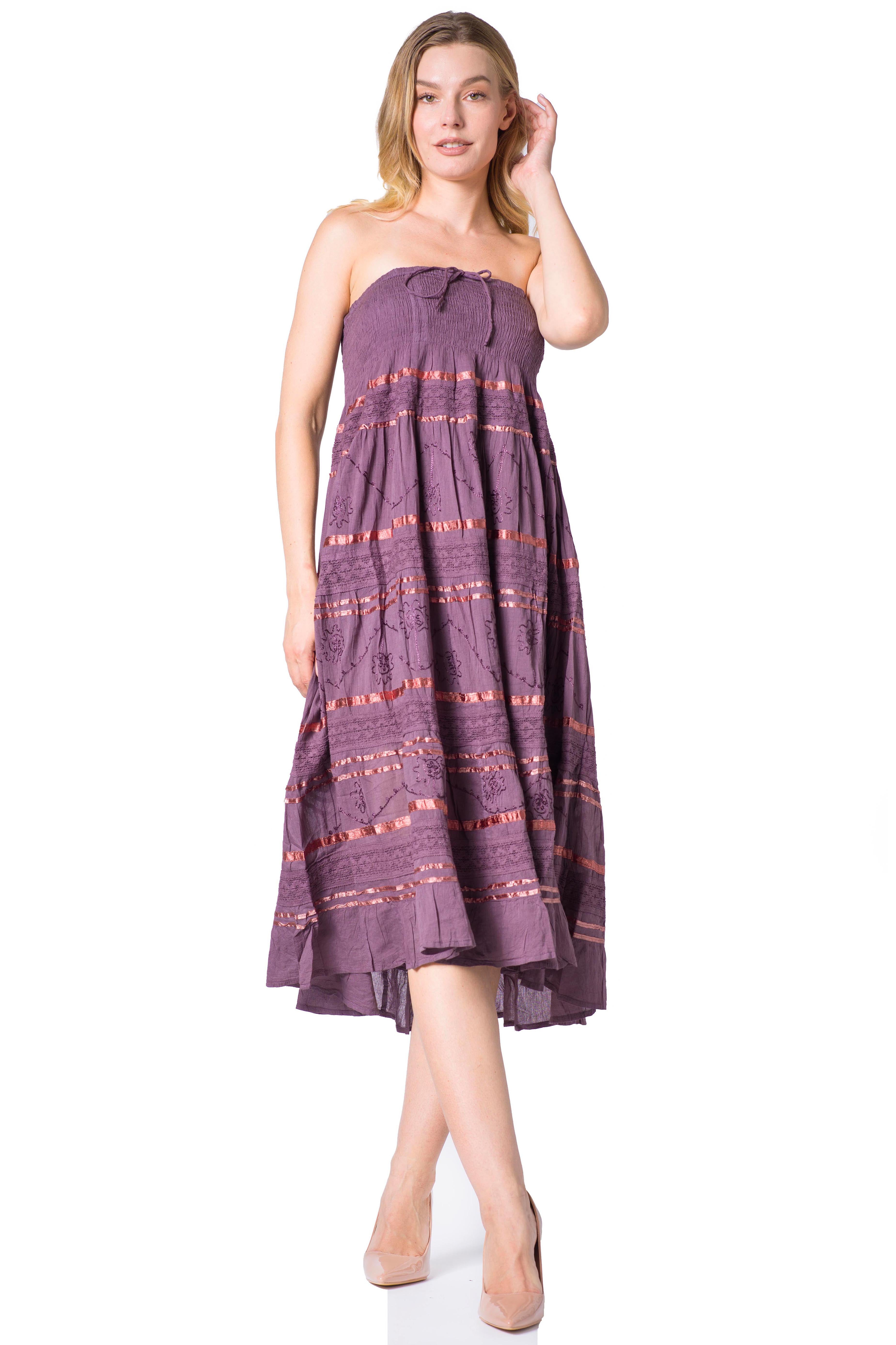 Woman wearing a purple strapless dress with a pattern on a white background