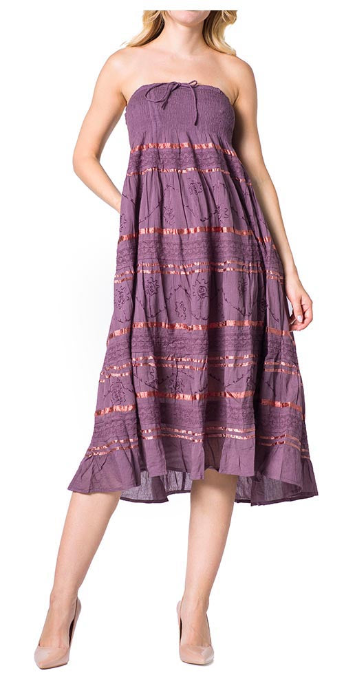 Woman wearing a strapless purple dress with red patterns on a white background