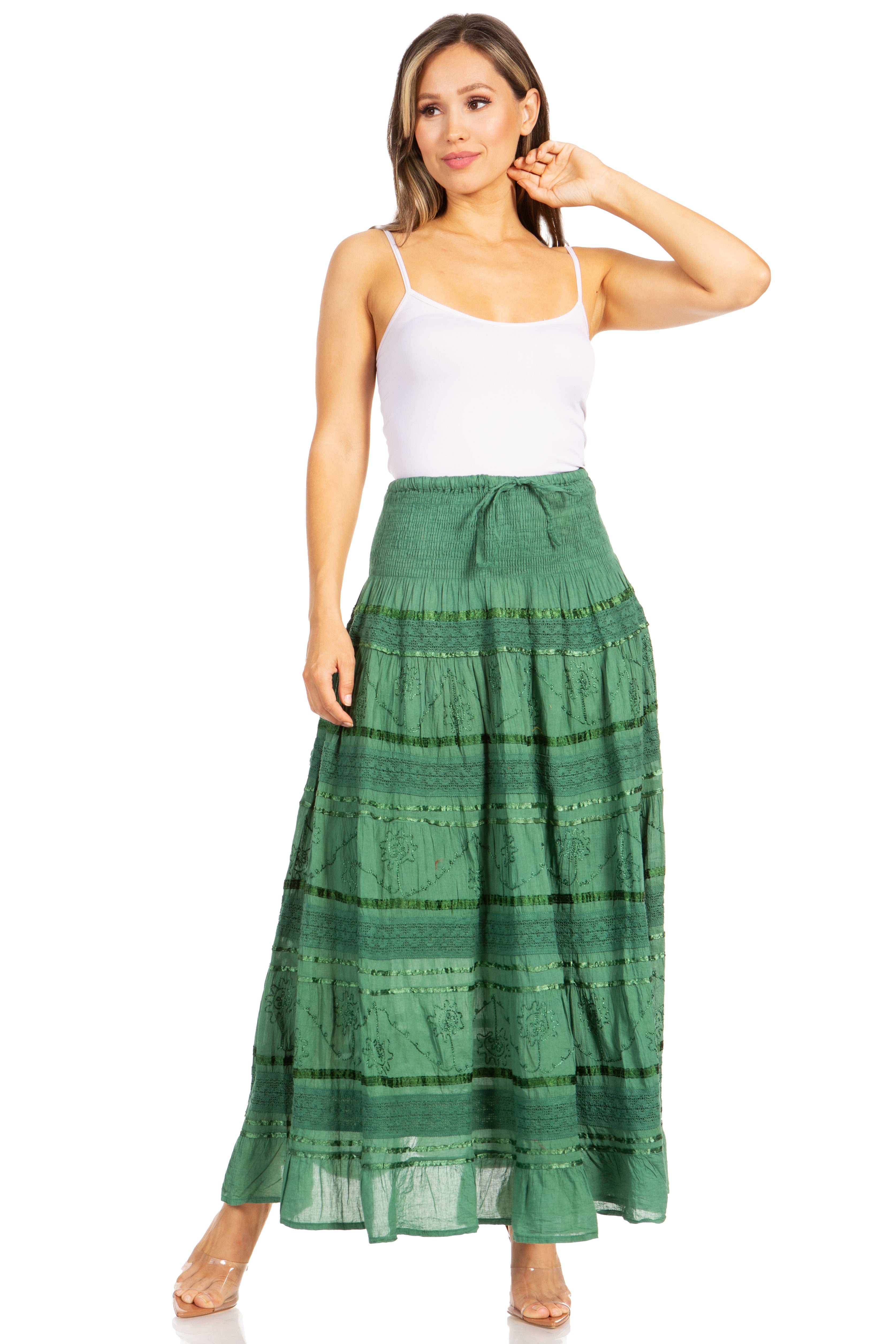 Woman wearing a green plaid skirt and white top on a white background