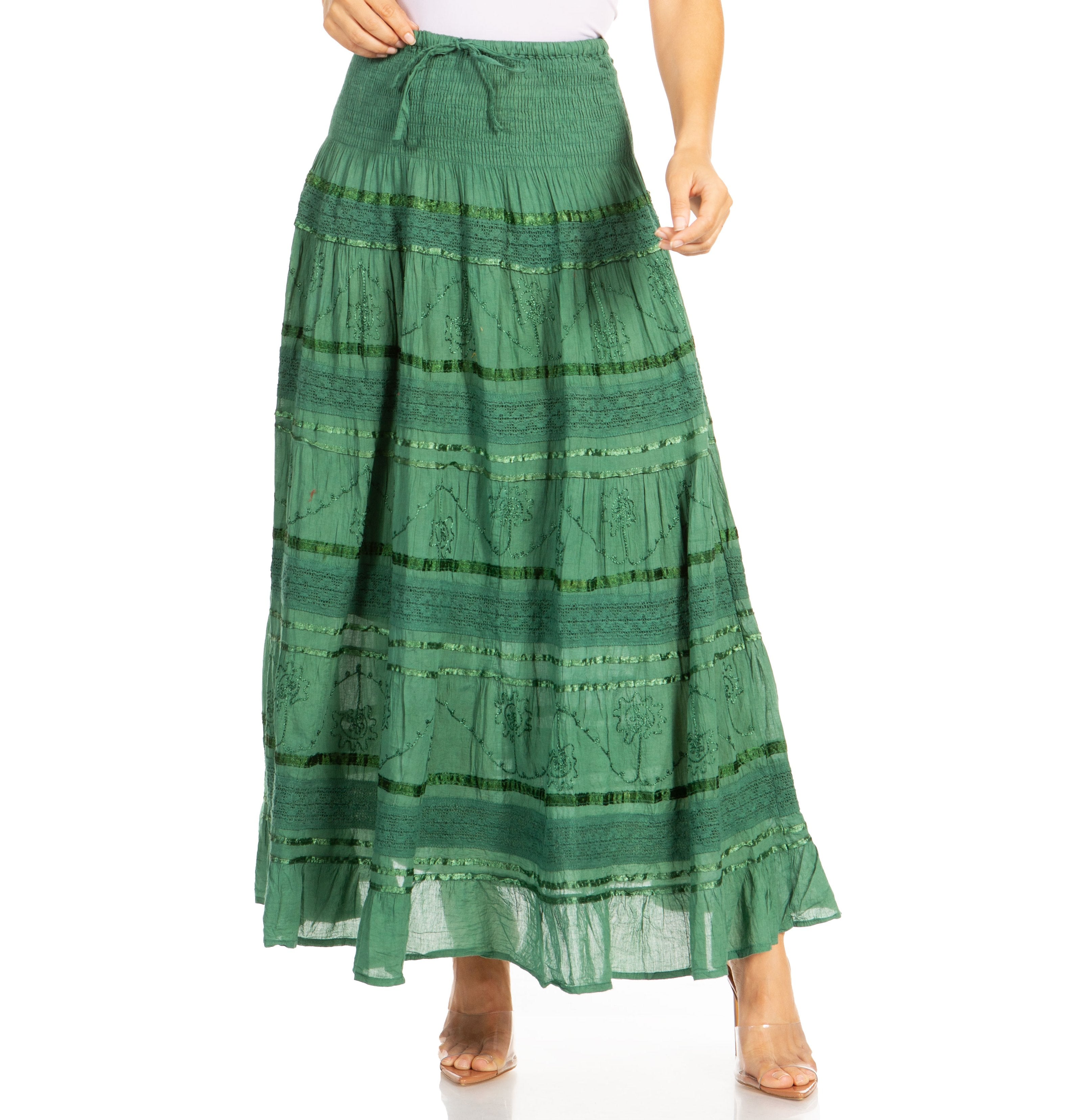 Green patterned skirt worn by a person on a white background