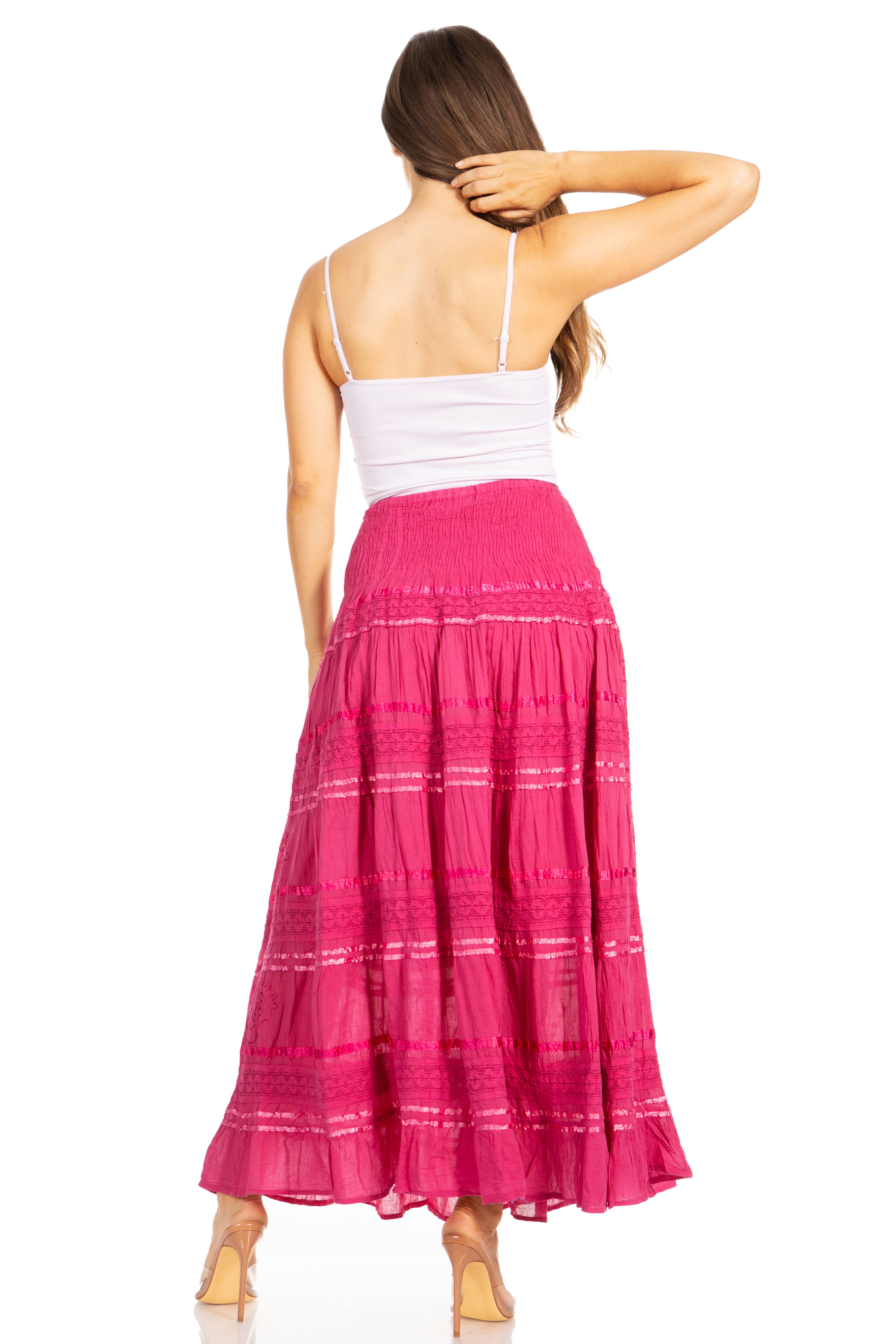 Woman wearing a white top and pink skirt on a white background