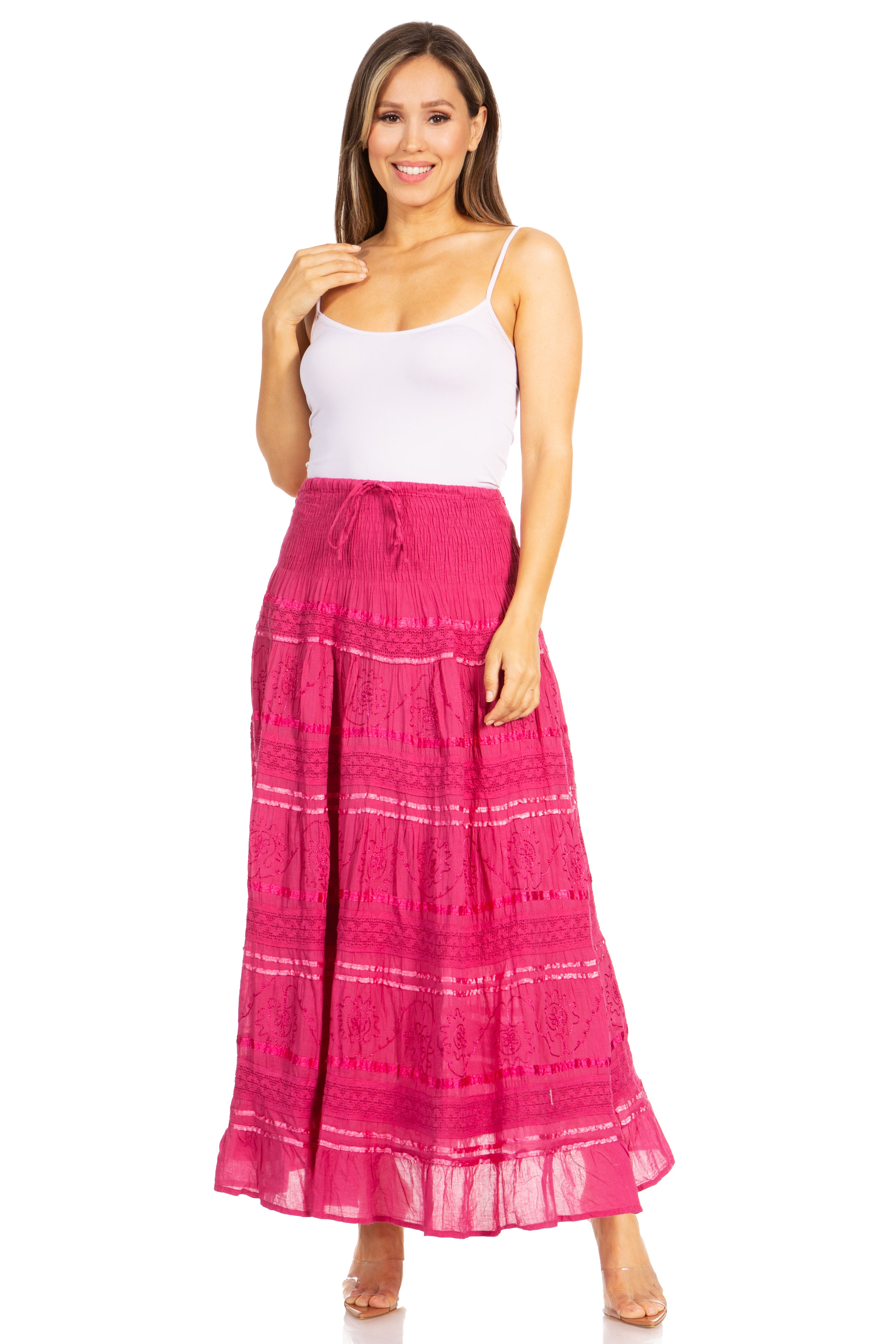 Woman wearing a white top and pink skirt on a white background
