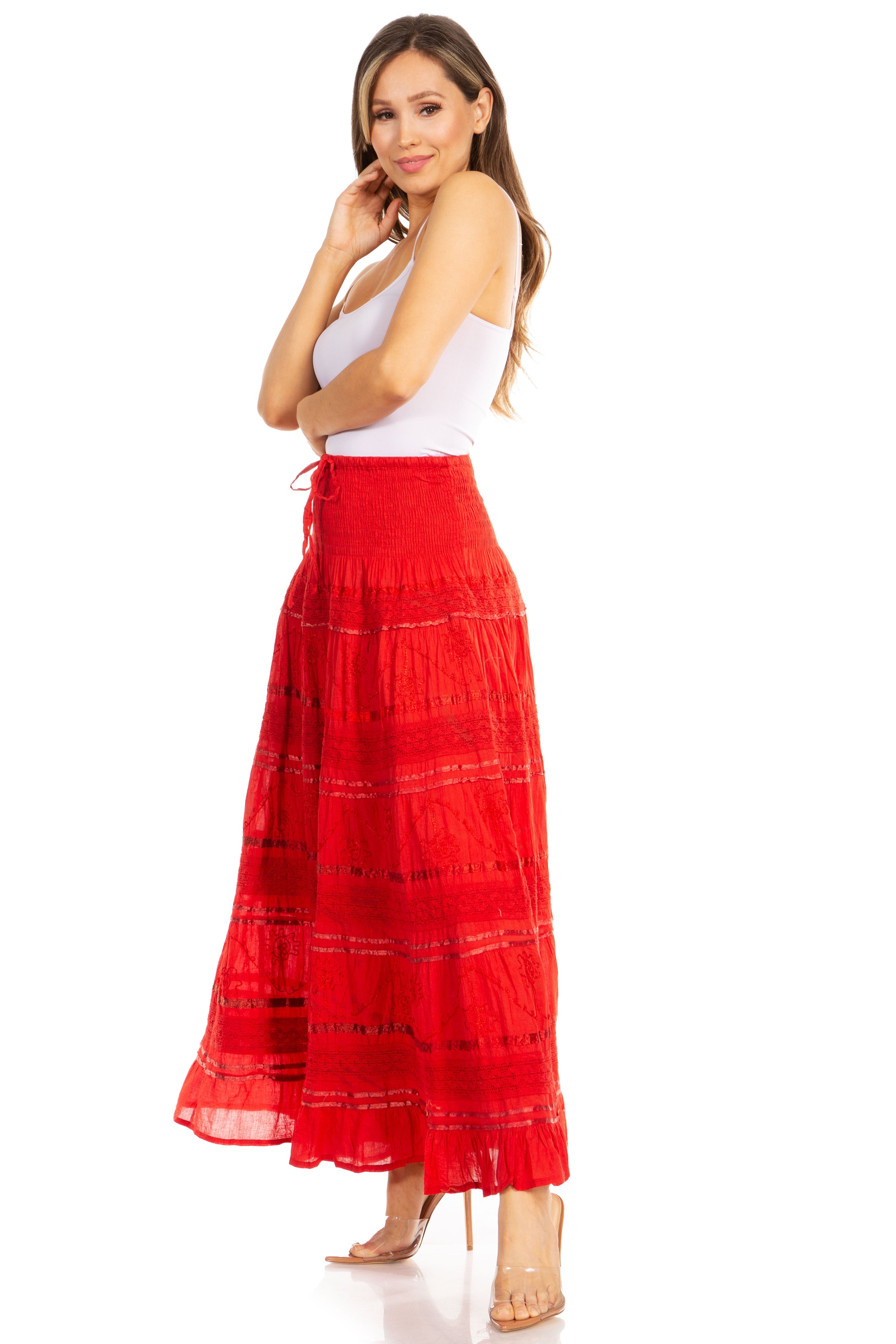 Woman wearing a red skirt and white top on a white background