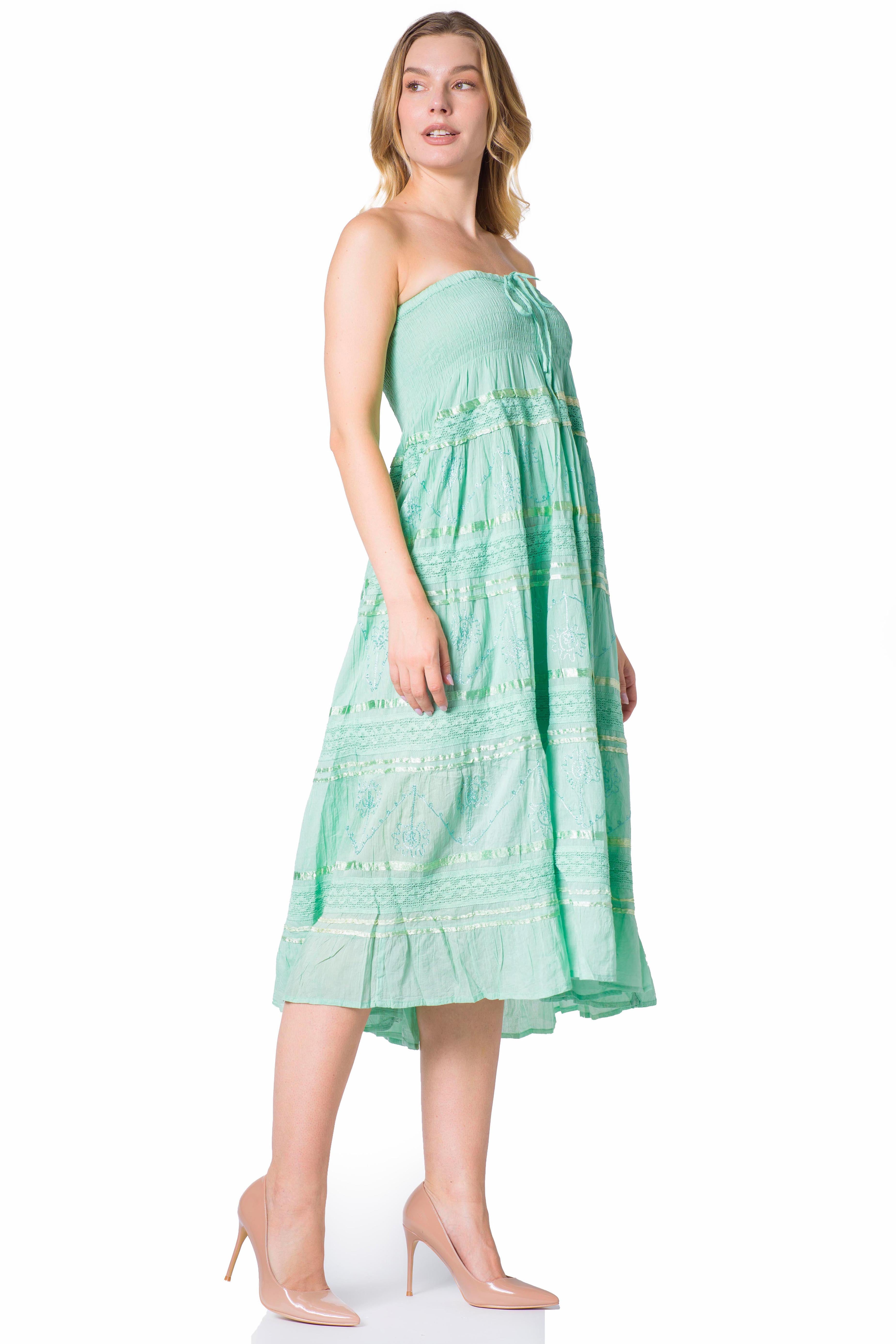 Woman wearing a light green strapless dress on a white background