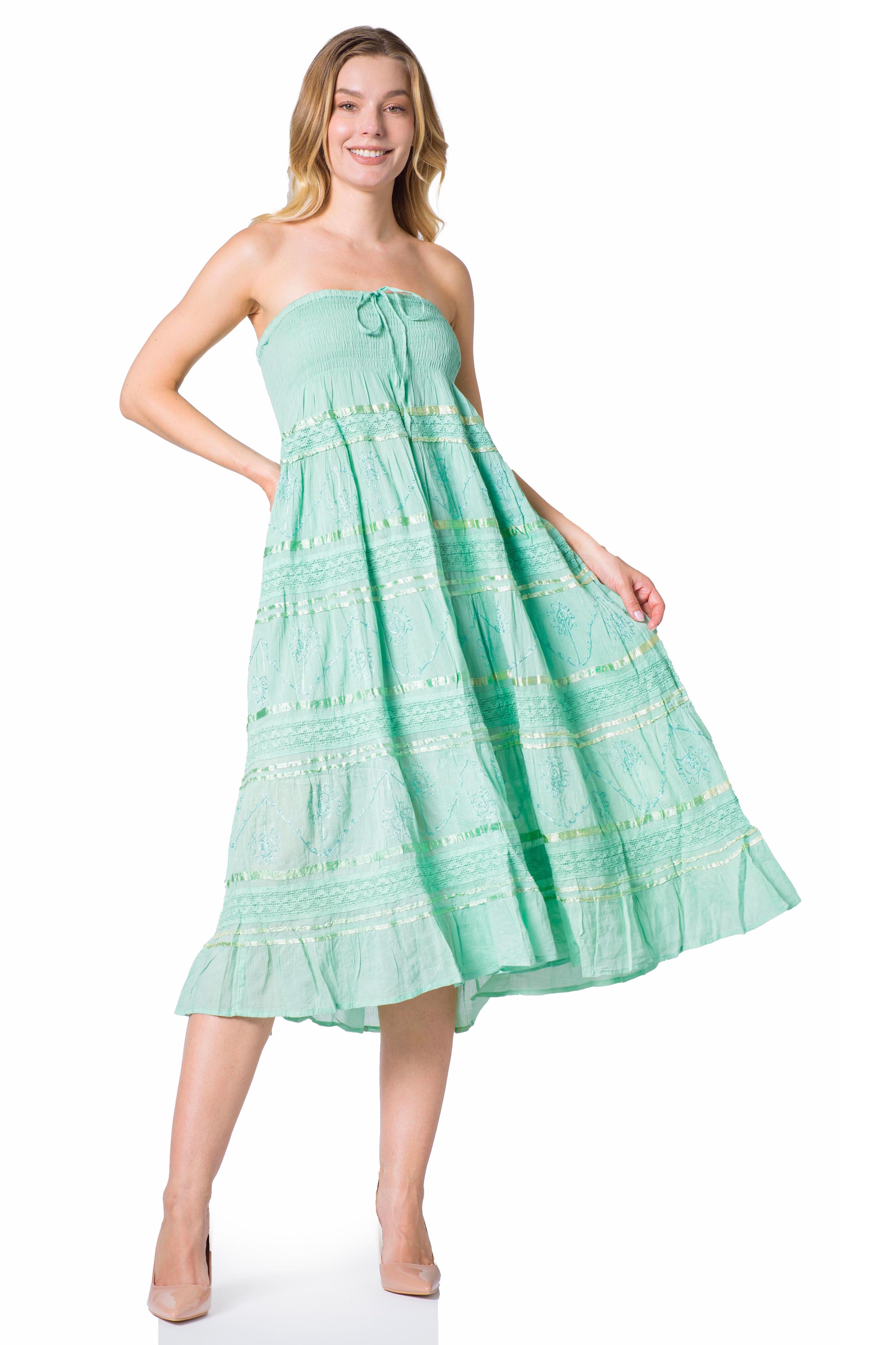 Woman wearing a light green strapless dress on a white background