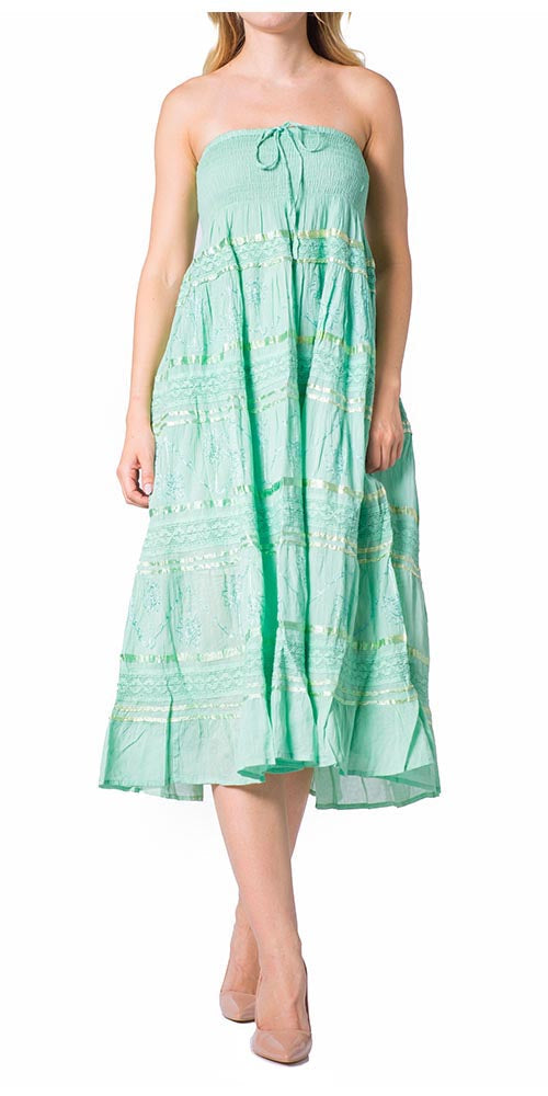 Woman wearing a strapless green dress with a white background