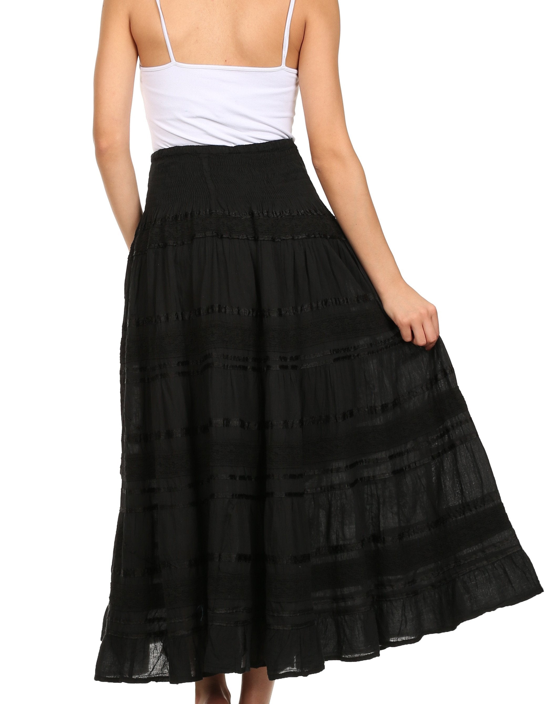 Black lace skirt worn by a person on a white background