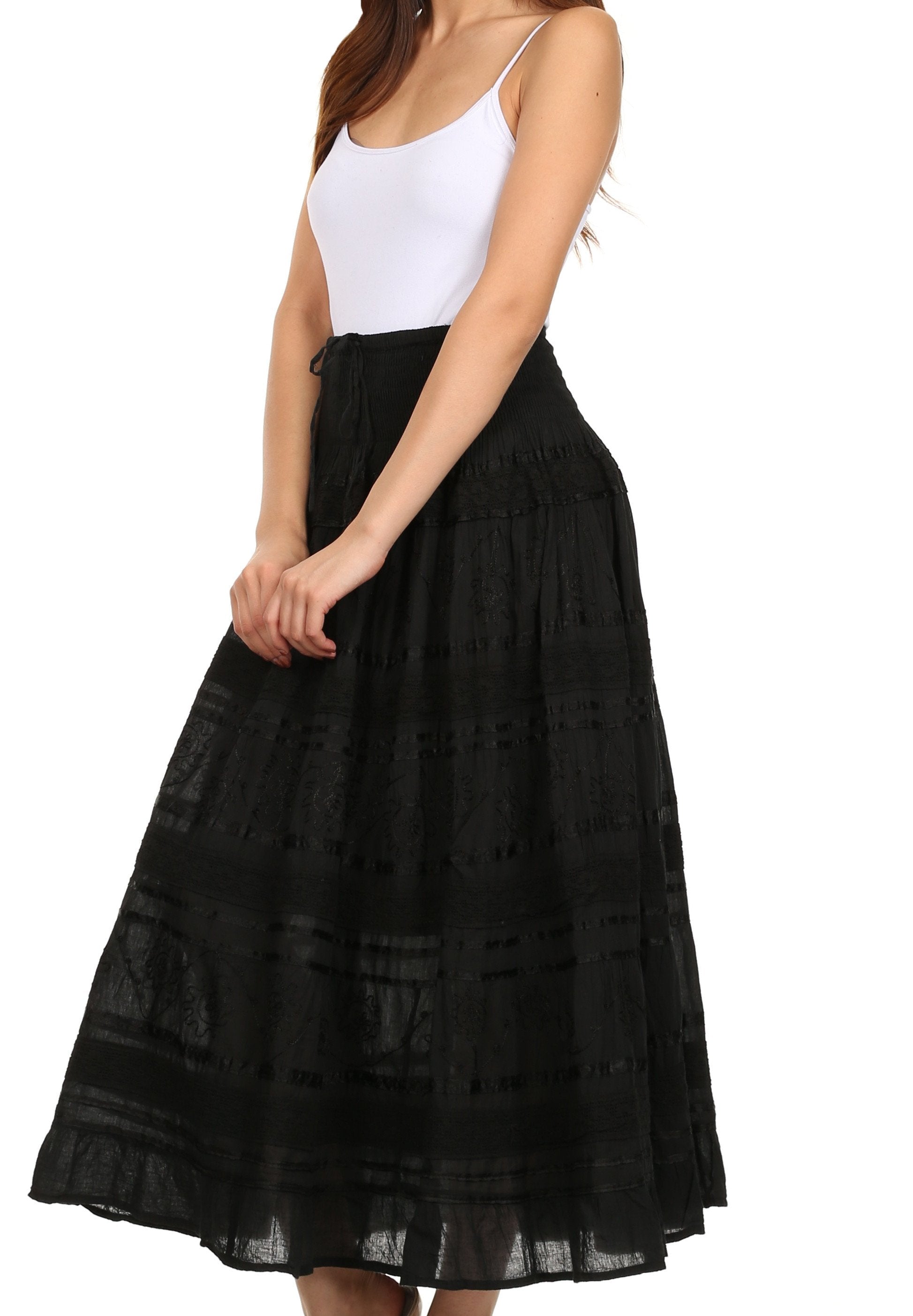 Black lace skirt worn by a person on a white background
