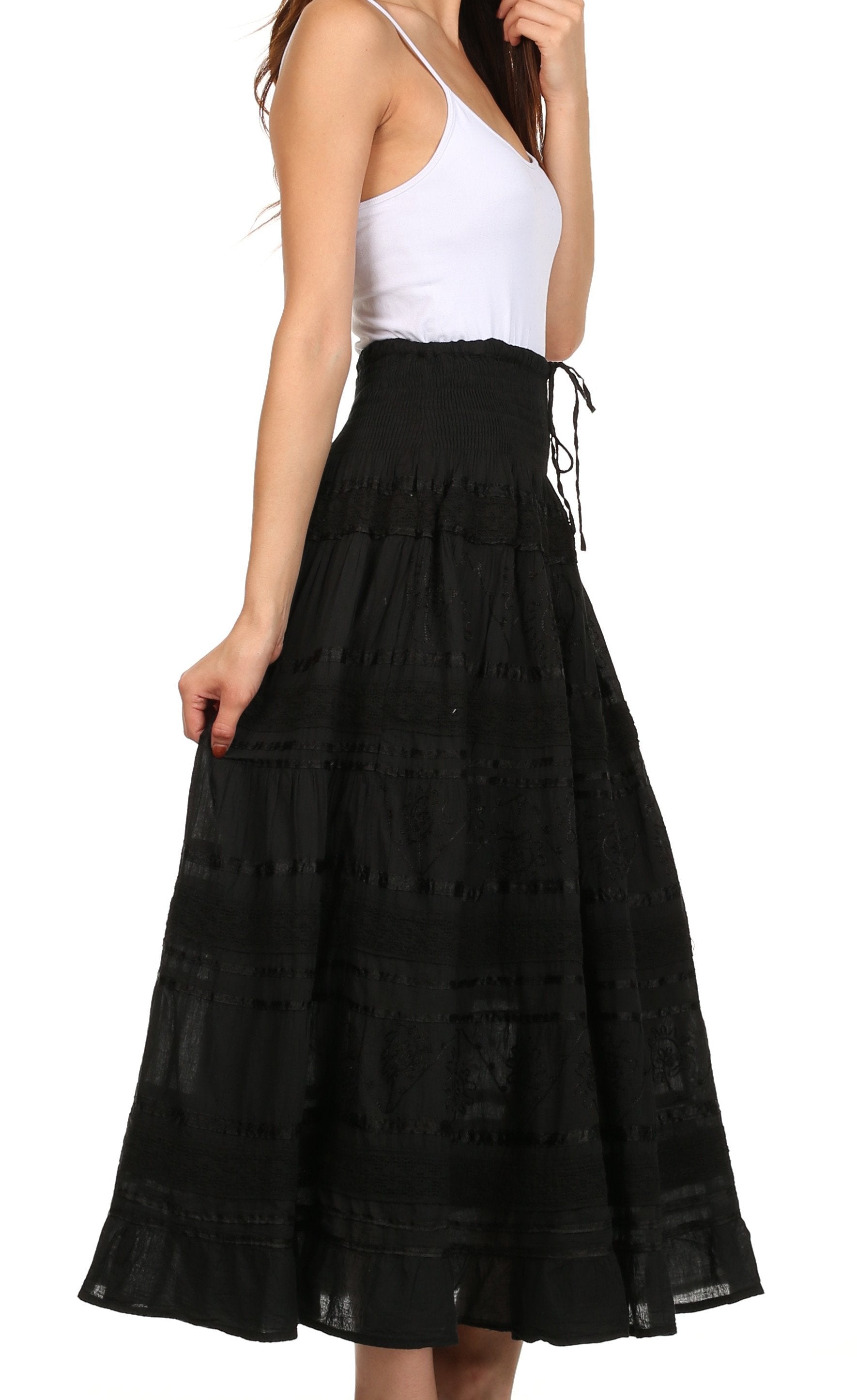 Black lace skirt worn by a person on a white background