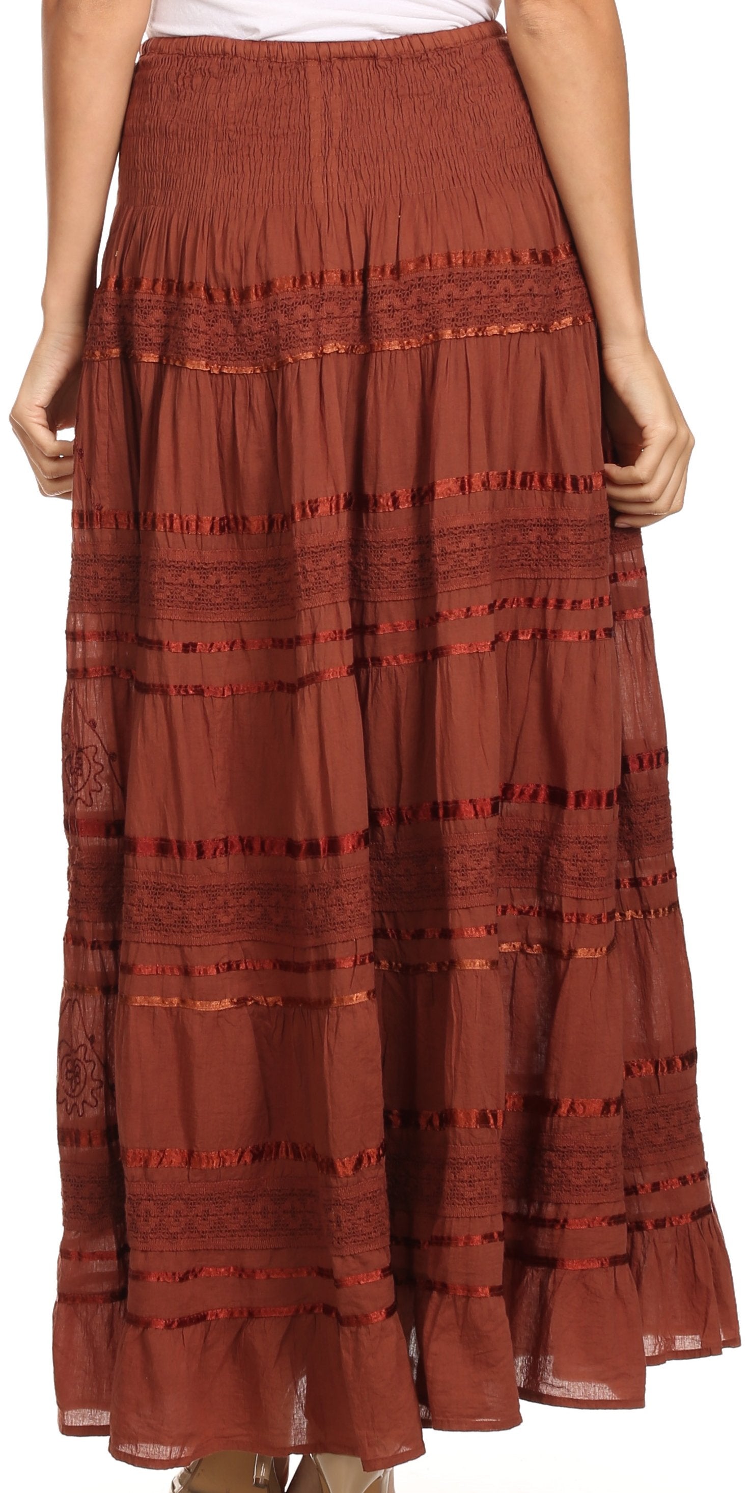 Reddish-brown tiered skirt worn by a person on a white background