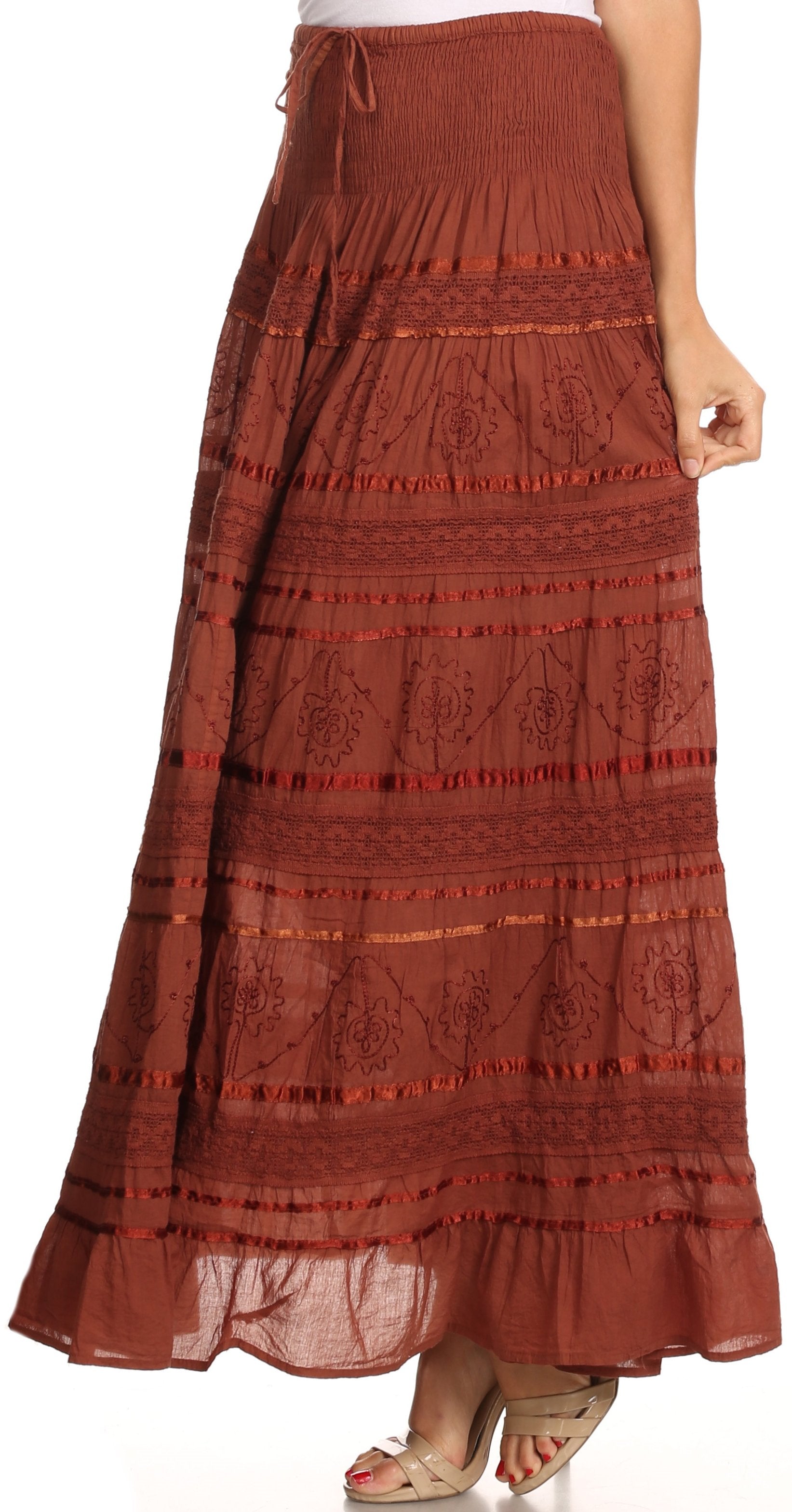 Brown patterned skirt worn by a person on a white background