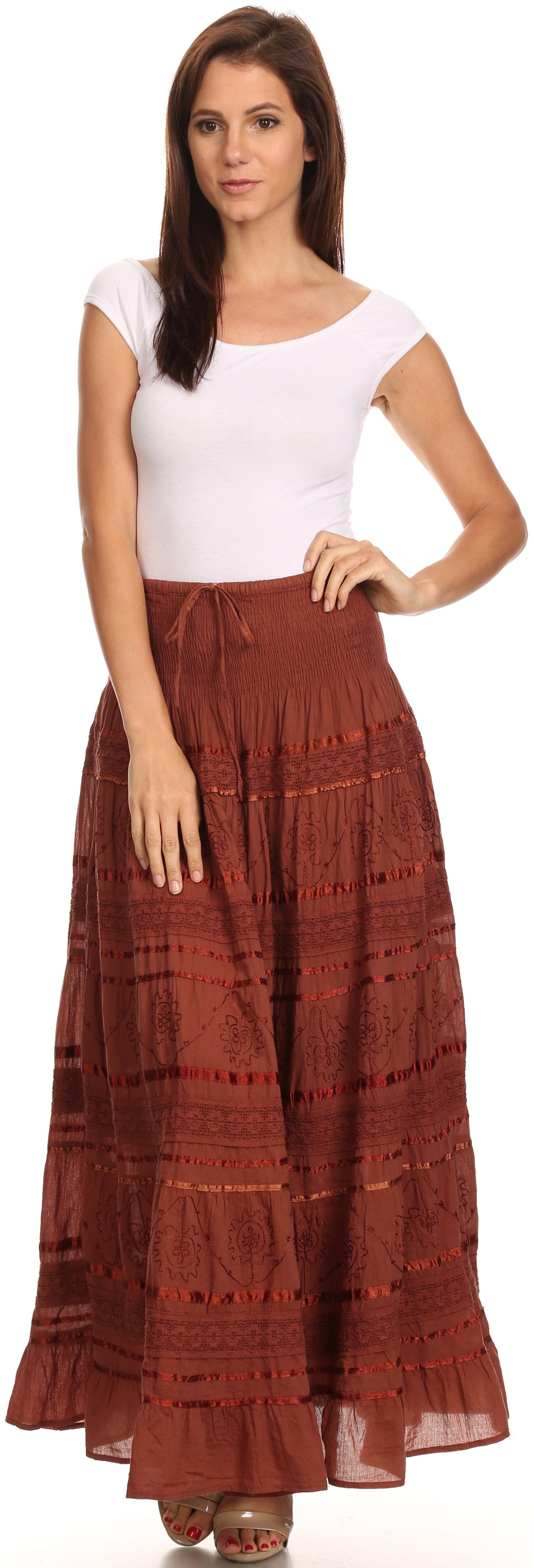 Woman wearing a white top and red patterned skirt on a white background