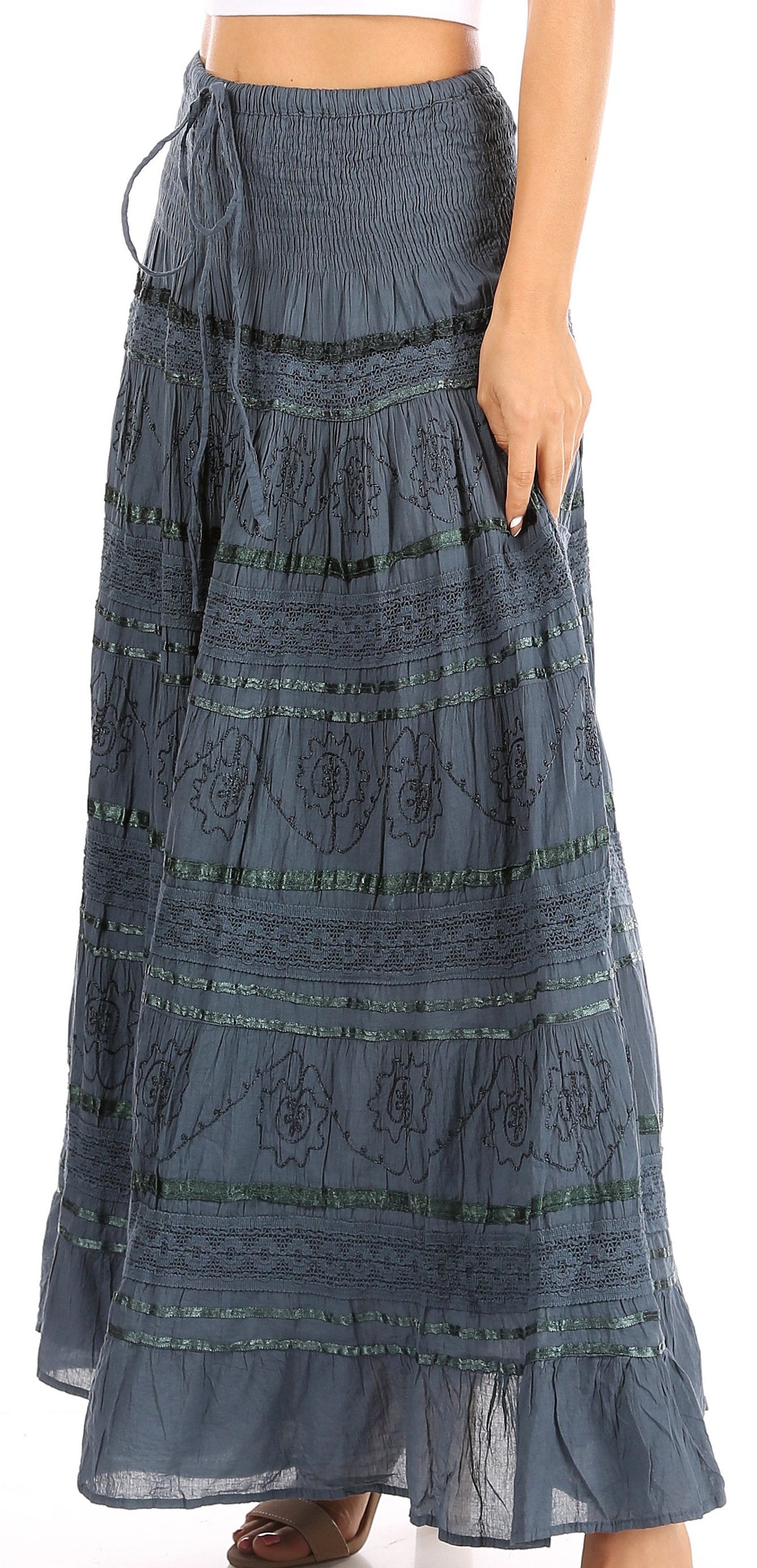 Long blue patterned skirt worn by a person on a white background