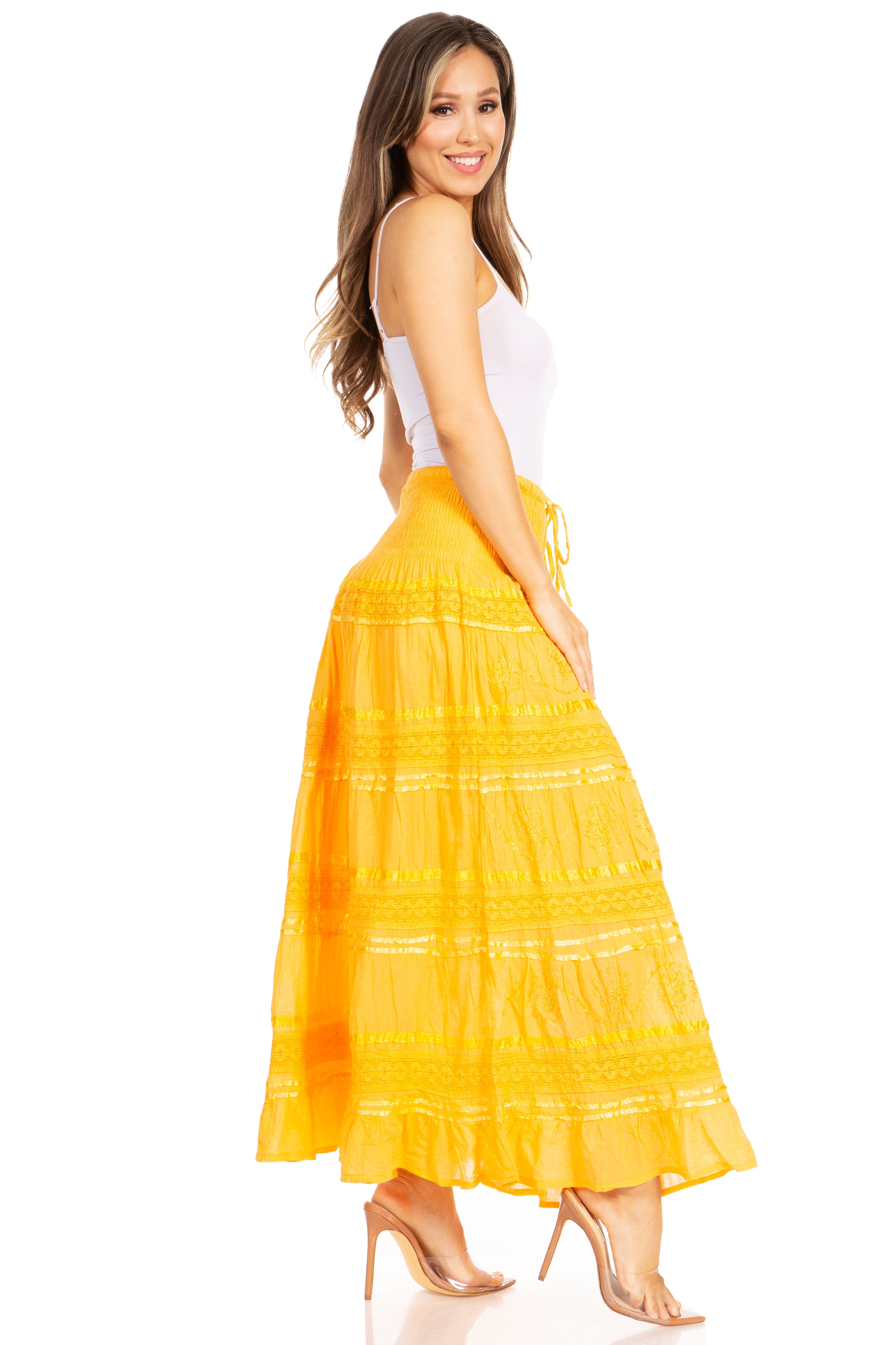 Woman wearing a yellow tiered skirt on a white background