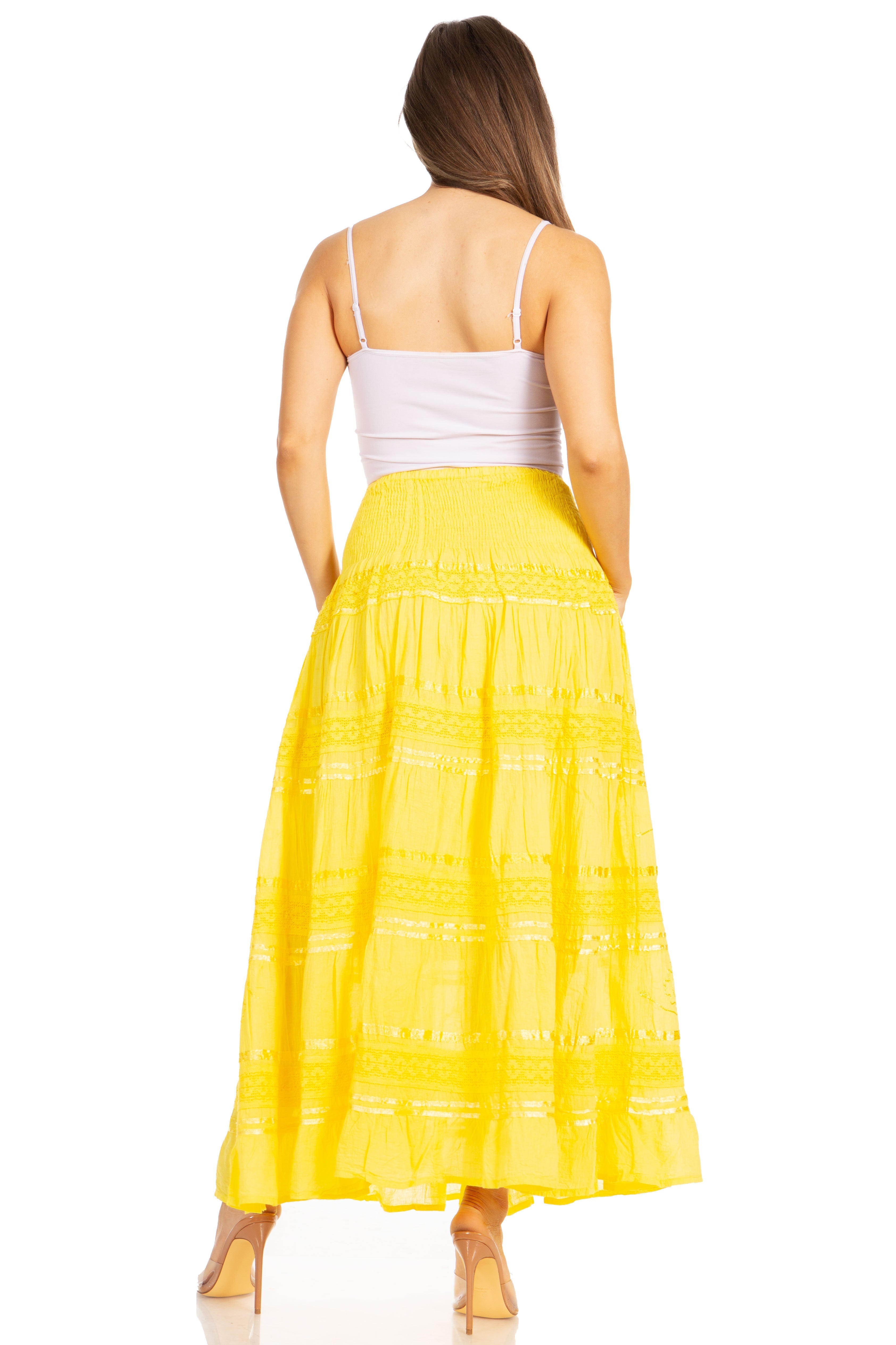 Woman wearing a yellow skirt and white top on a white background