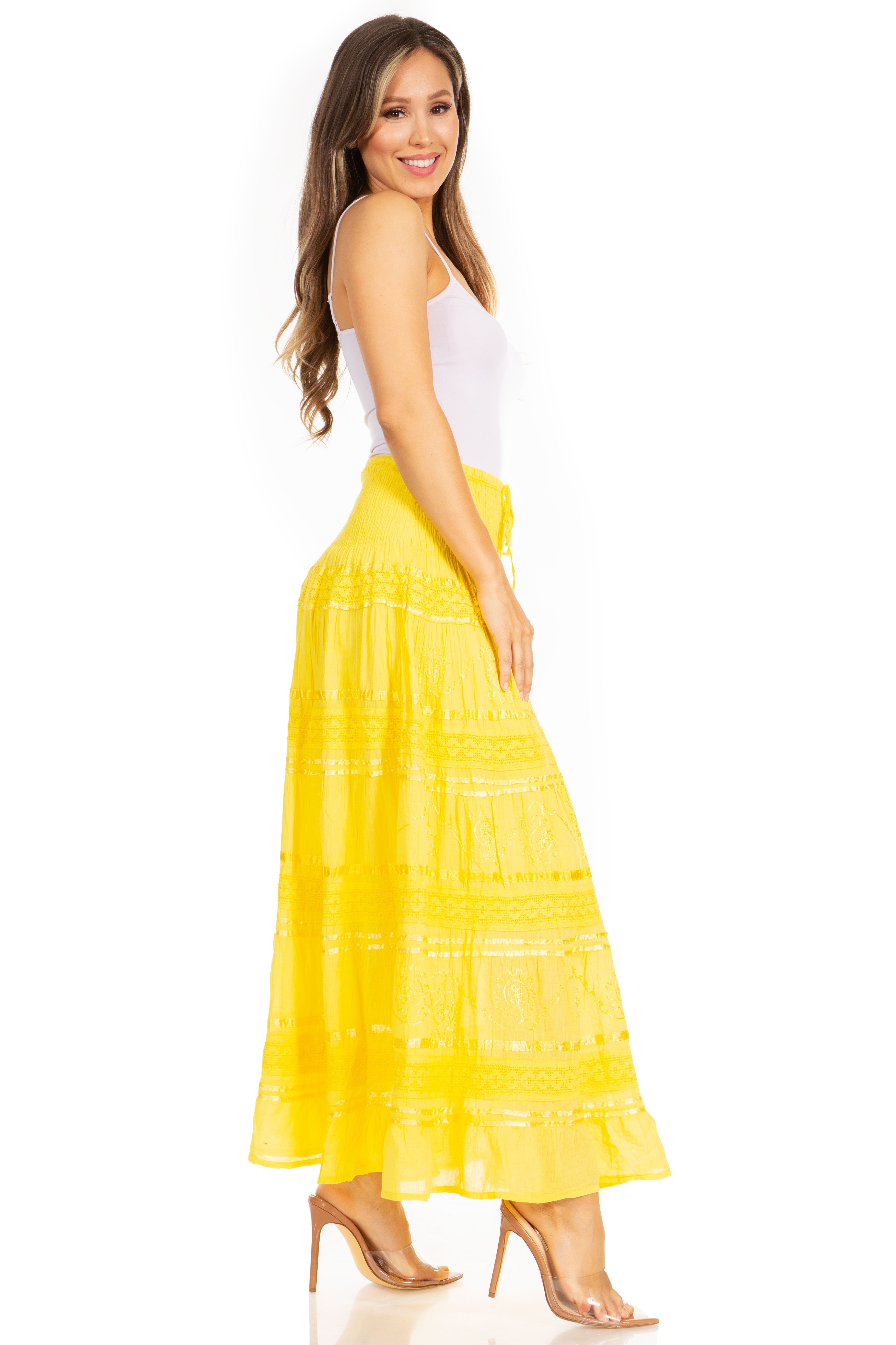 Woman wearing a yellow skirt and white top on a white background