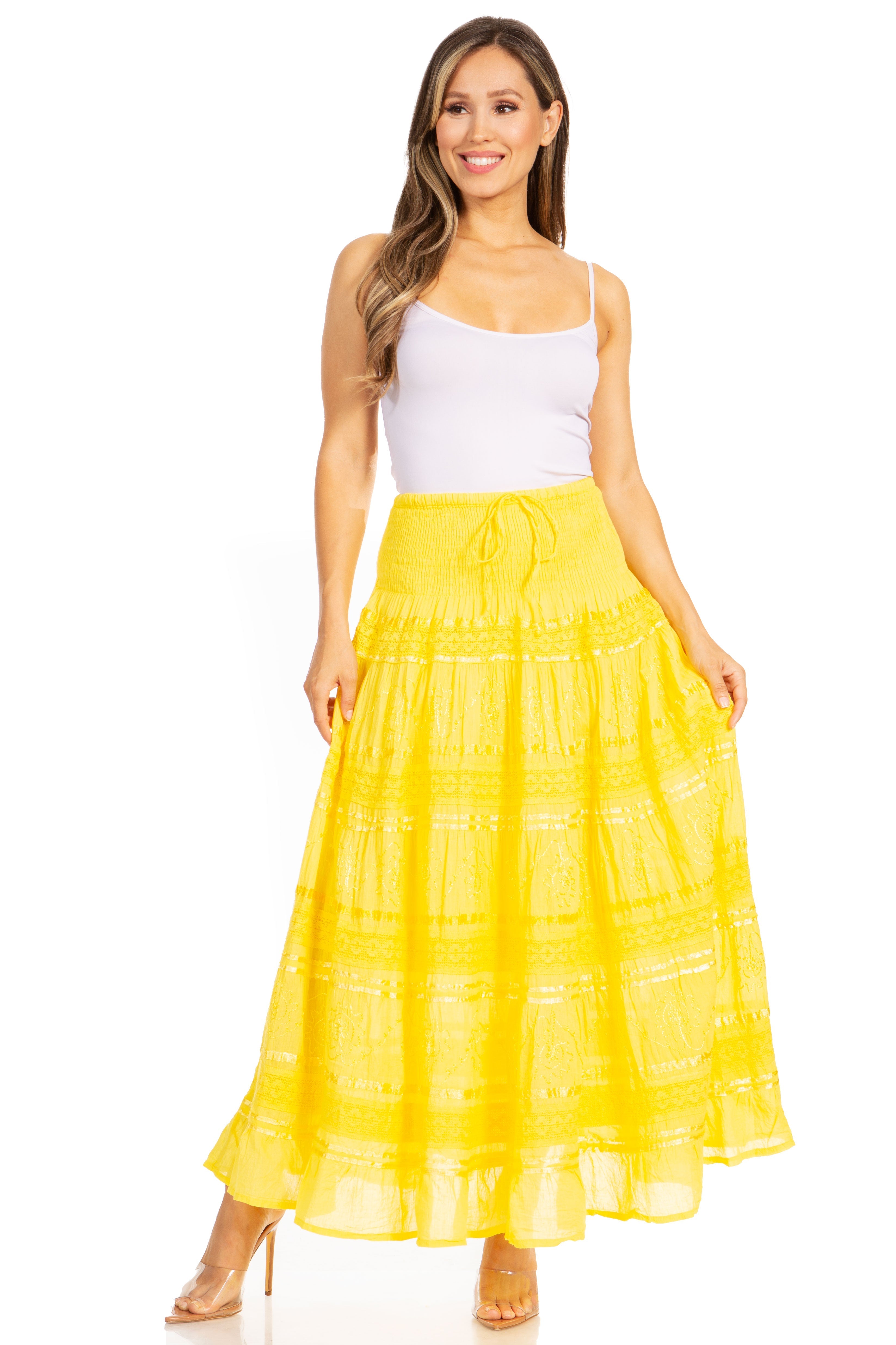 Woman wearing a yellow skirt and white top on a white background