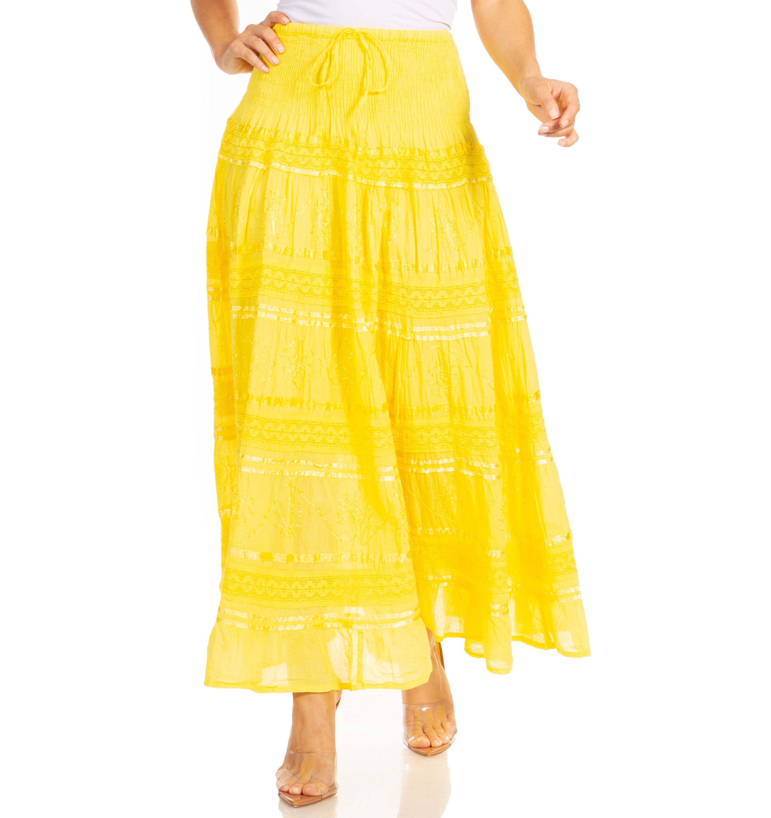 Yellow long skirt worn by a person on a white background