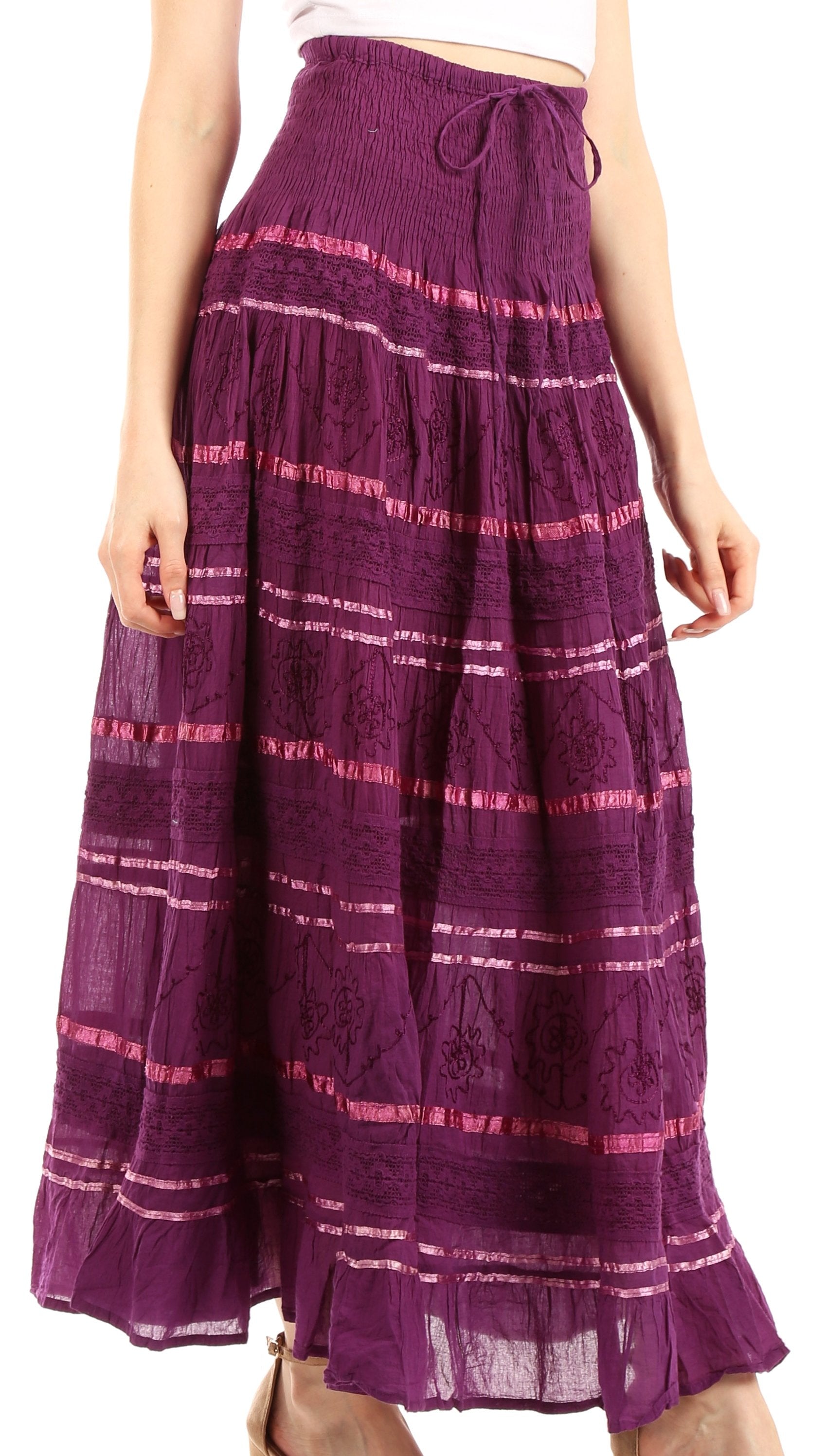 Purple patterned skirt worn by a person on a white background
