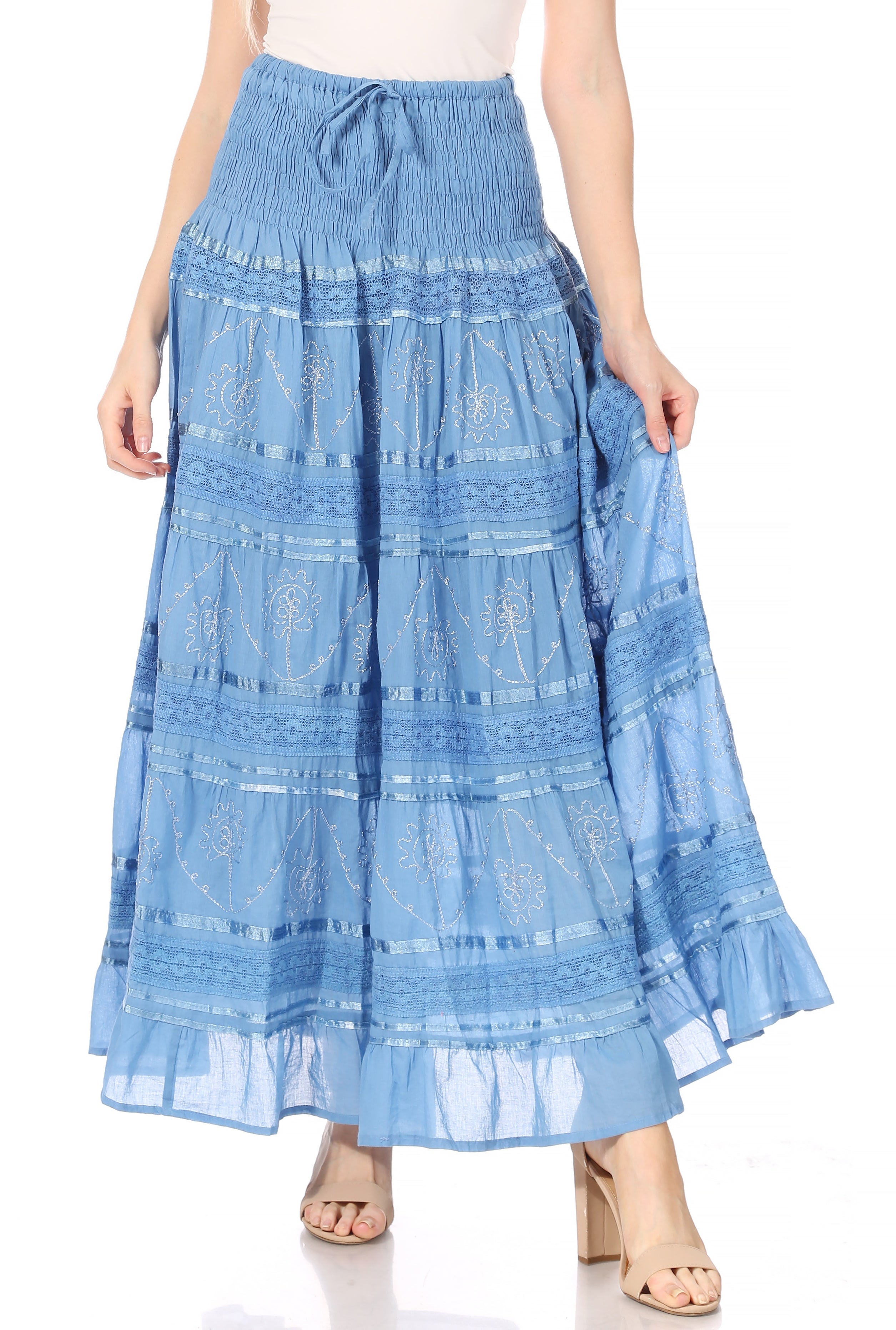 Blue embroidered skirt worn by a person on a white background