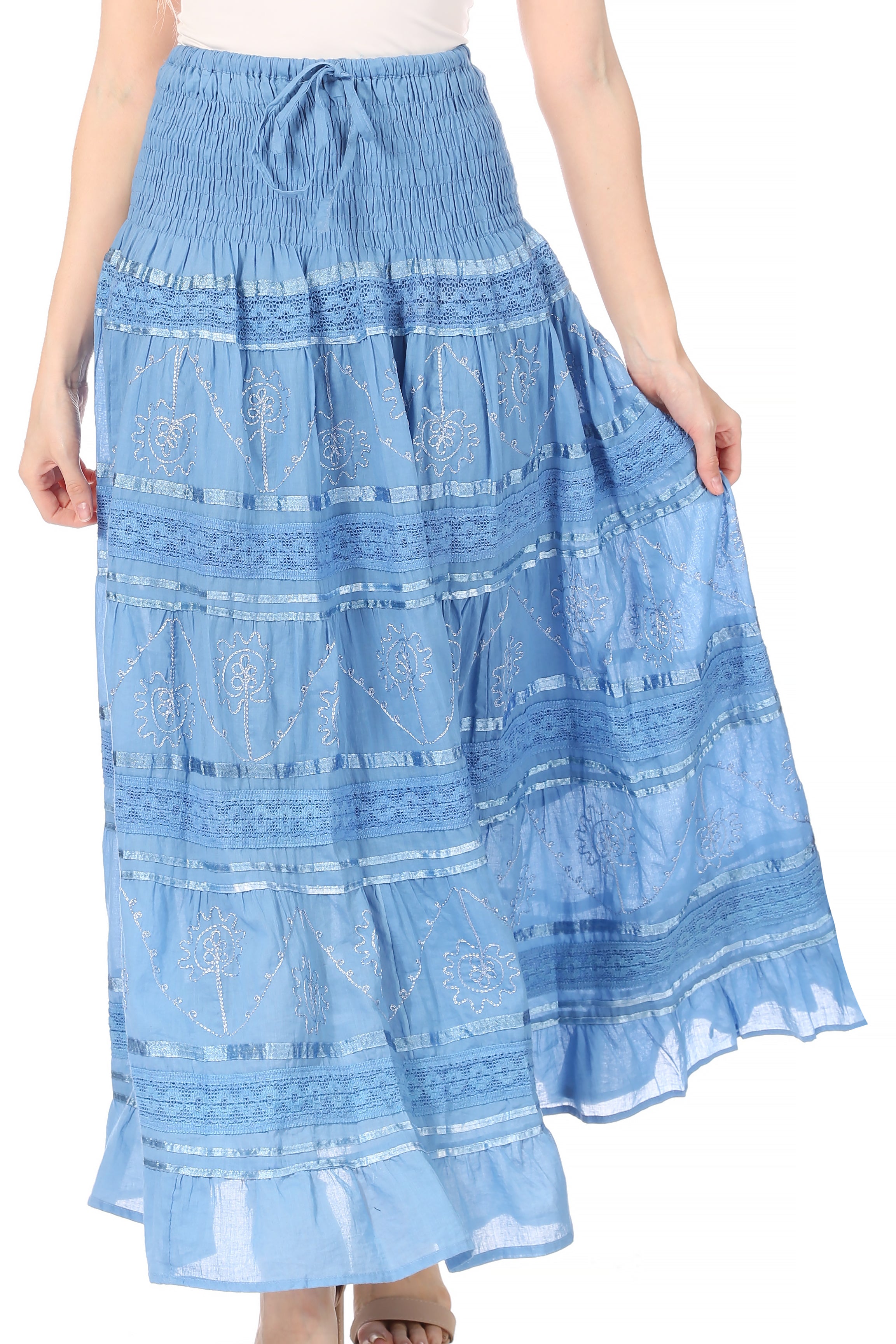 Woman wearing a blue embroidered skirt on a white background
