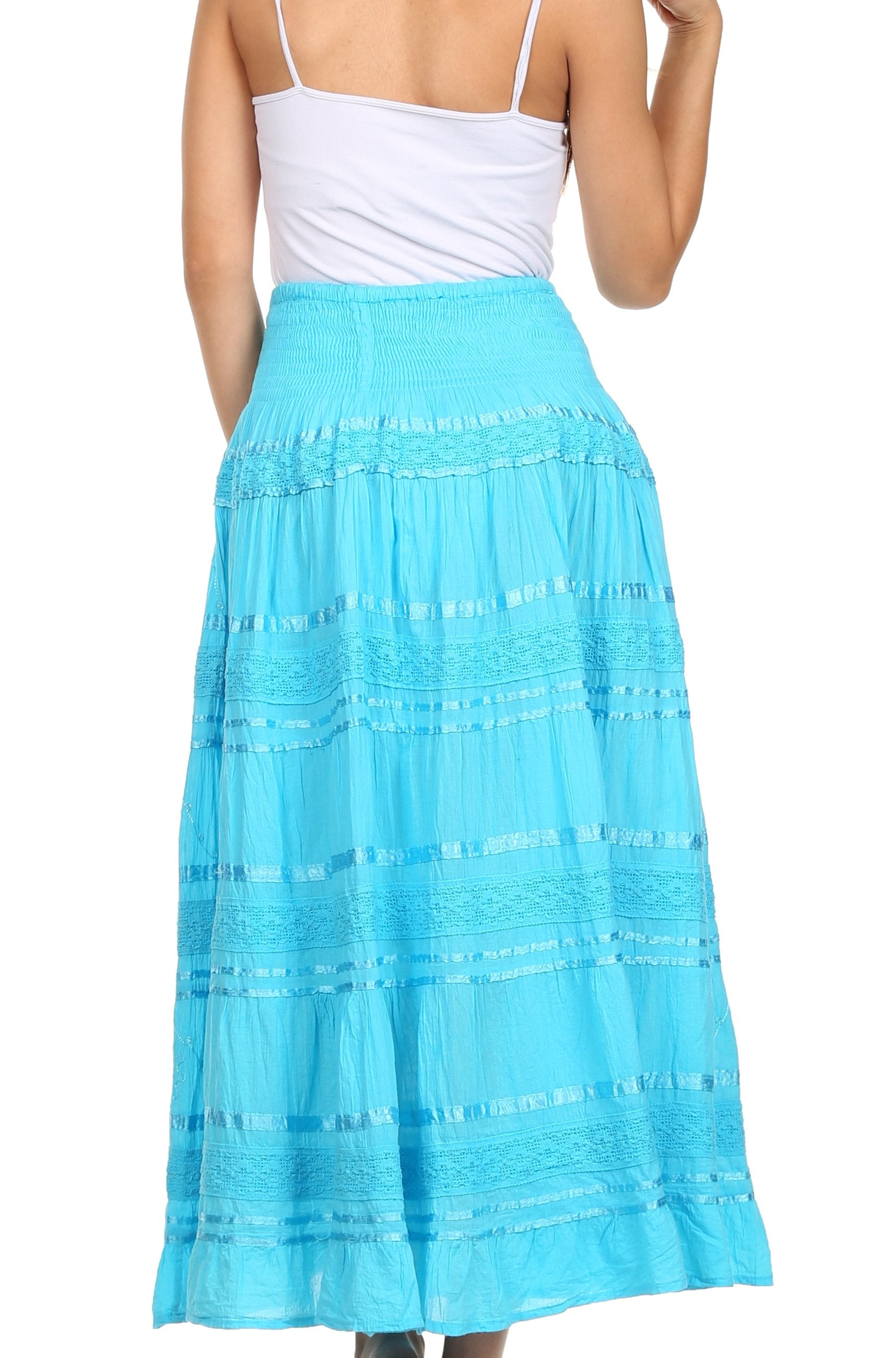 Woman wearing a white top and blue skirt on a white background